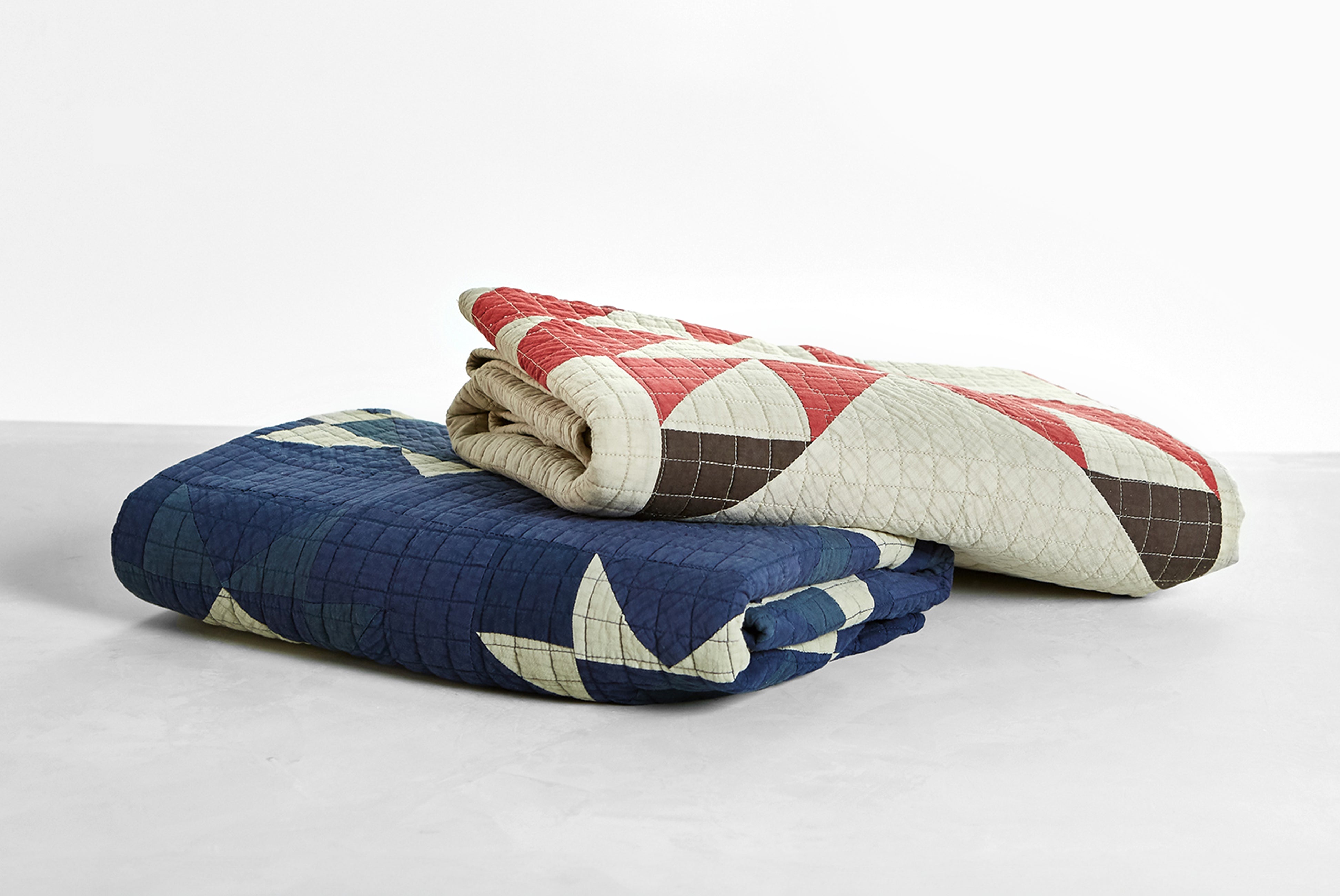 Basshu Quilts shown folded in blue and beige colors