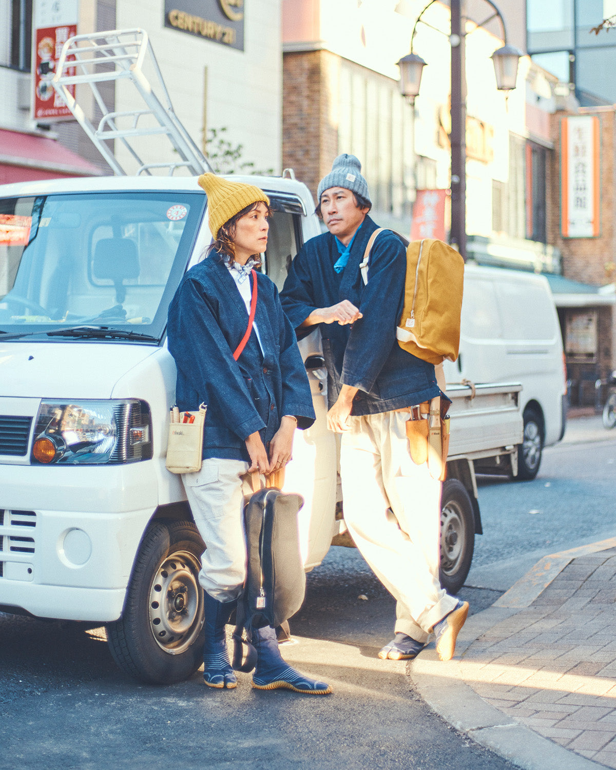 Niwaki Wool Knit Hat in yellow mustard and grey gray color shown on two people street style. Fisherman style beanie.