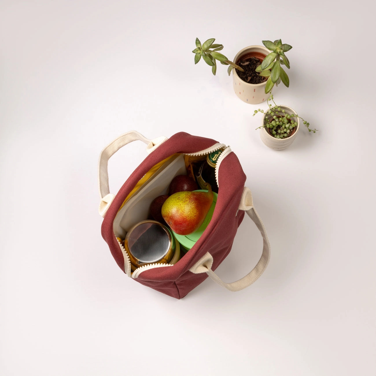 Organic Cotton Zipper Lunch Bag shown in Vintage Burgundy from above unzipped showing contents inside