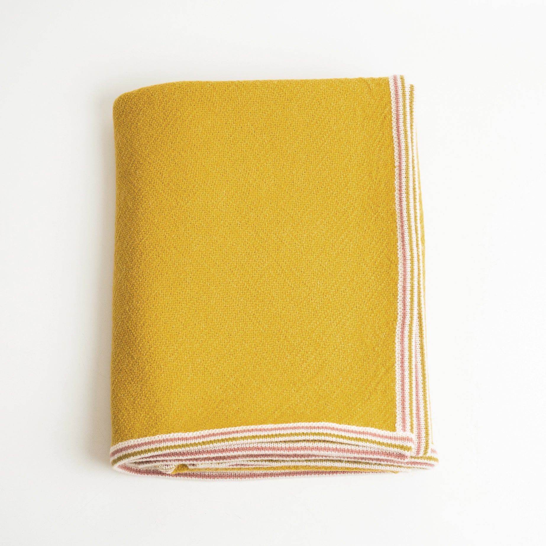 Alpaca Wool blanket in Citrine color shown folded on white background