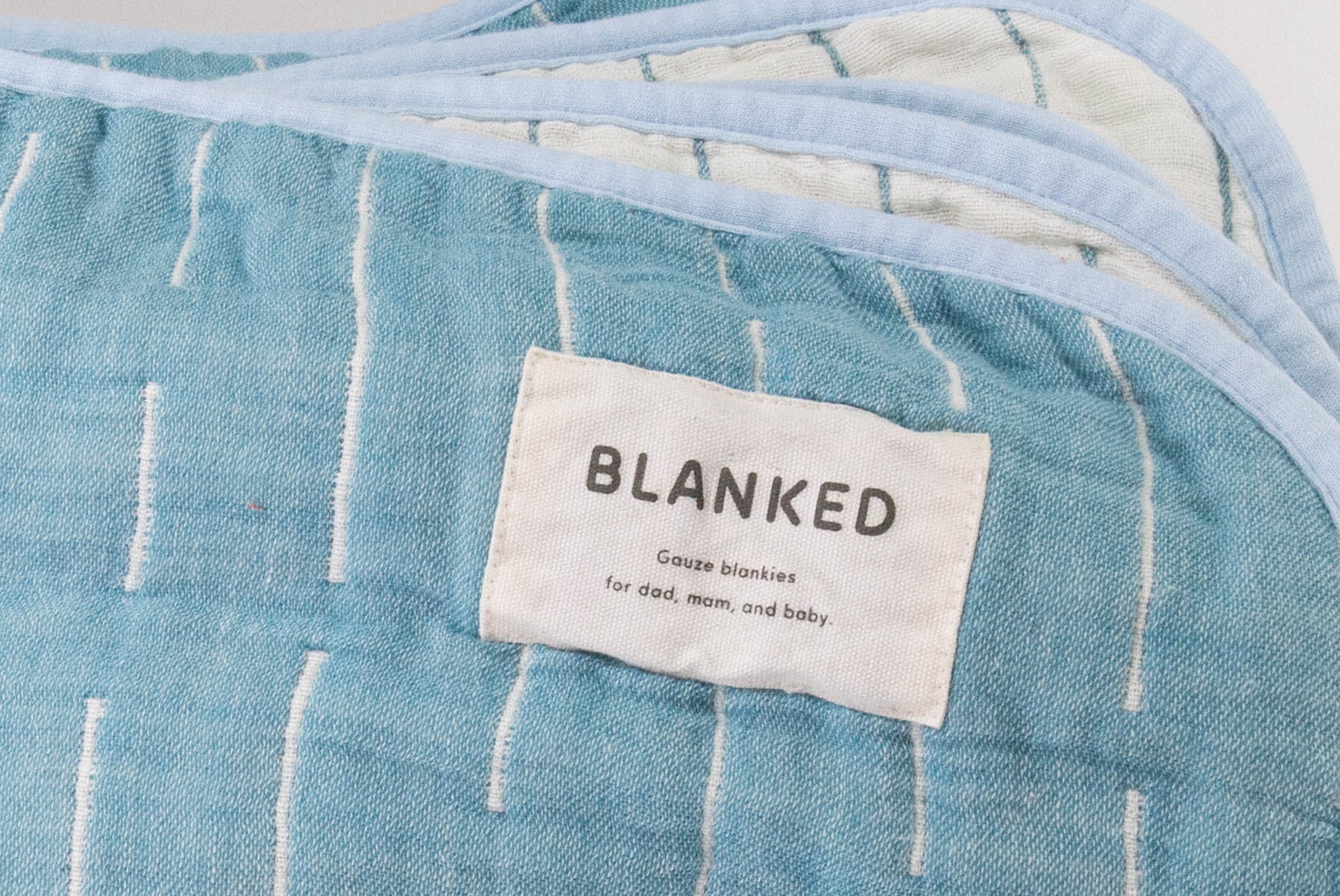 Close up of corner and label of Japanese Cotton Blanket by Blanked, shown in Shitoshito (blue & white), on white background