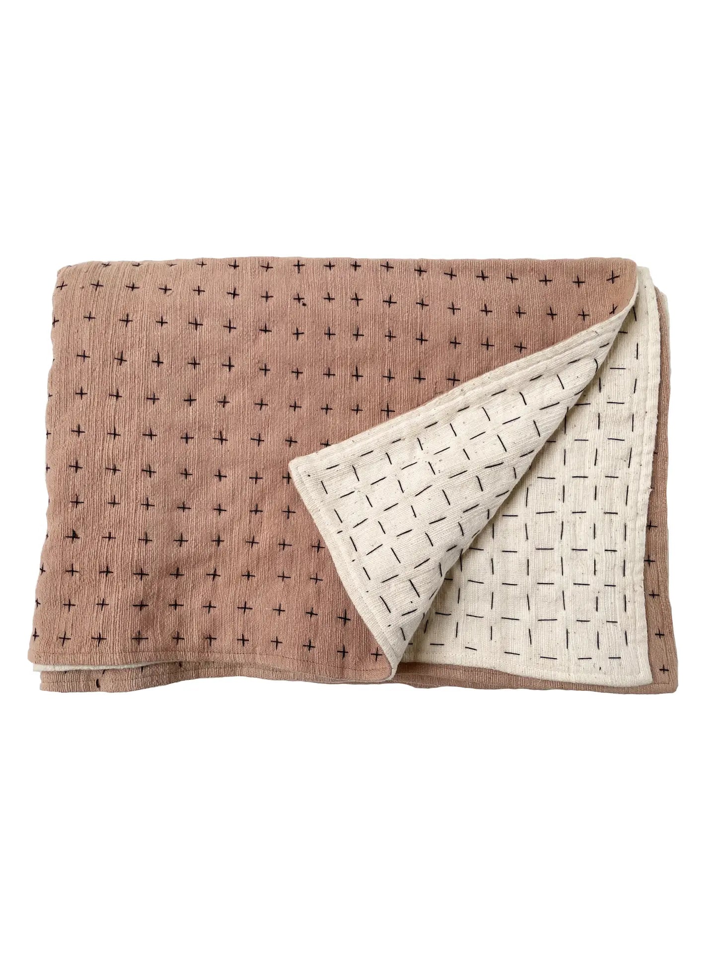 Handmade blanket by Happy French Gang, shown folded in Himalayan and natural color with corner folded up, on white background