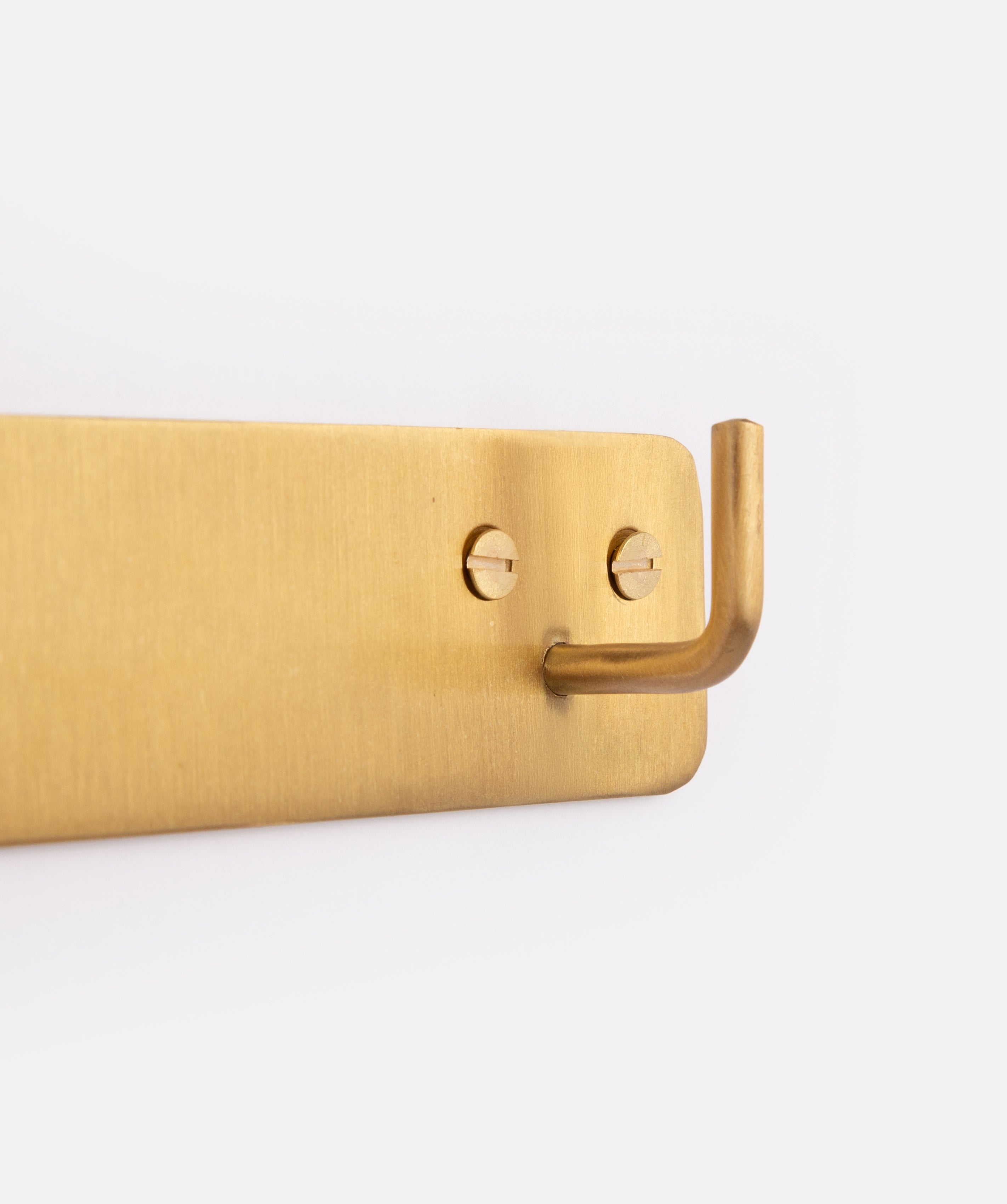 Close Up of Brass Triple Hook by Fog Linen on White Background