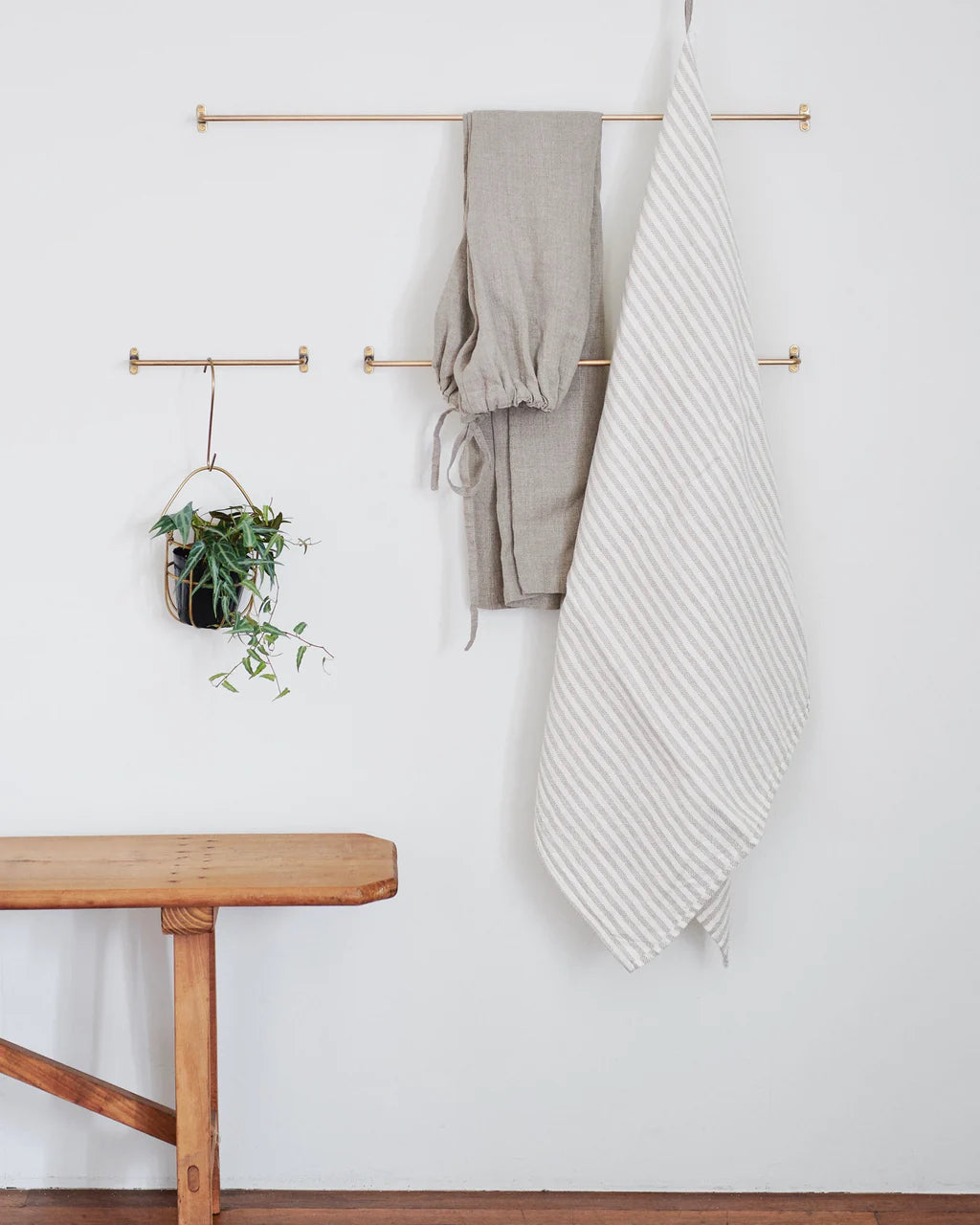 Fog Linen Brass Towel Bars shown on white background, in use