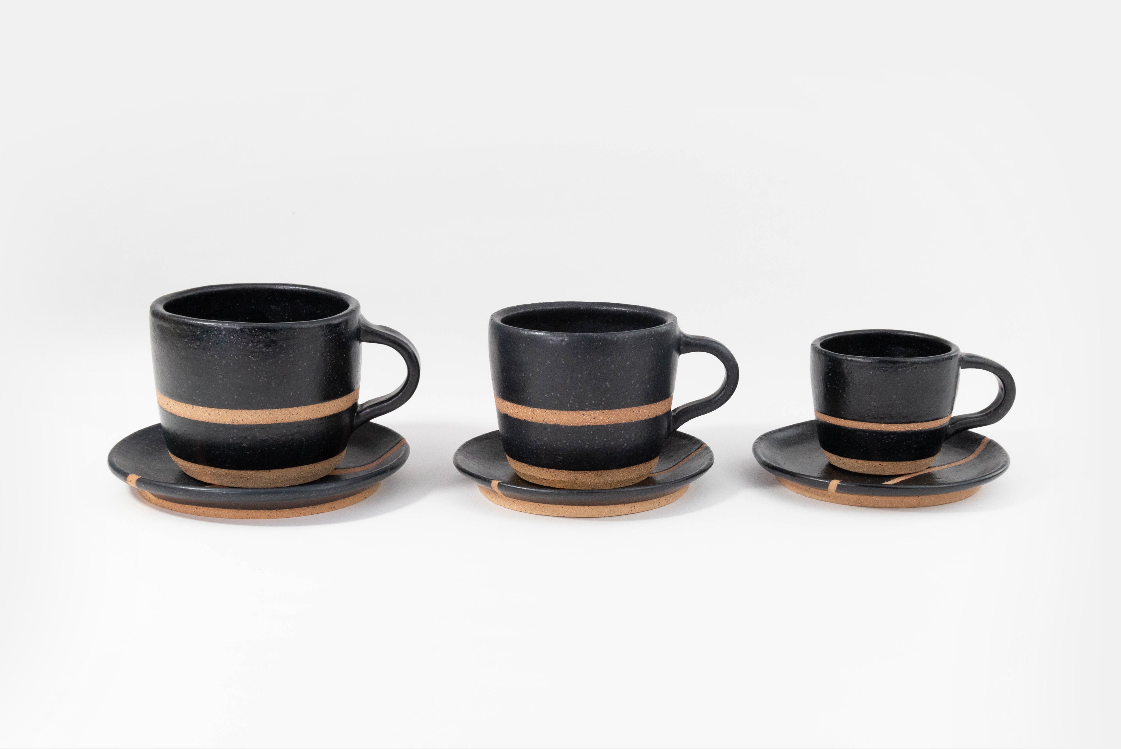 Fred James Pottery matte black espresso cappuccino latte coffee cups with saucer dish shown in three sizes on white background