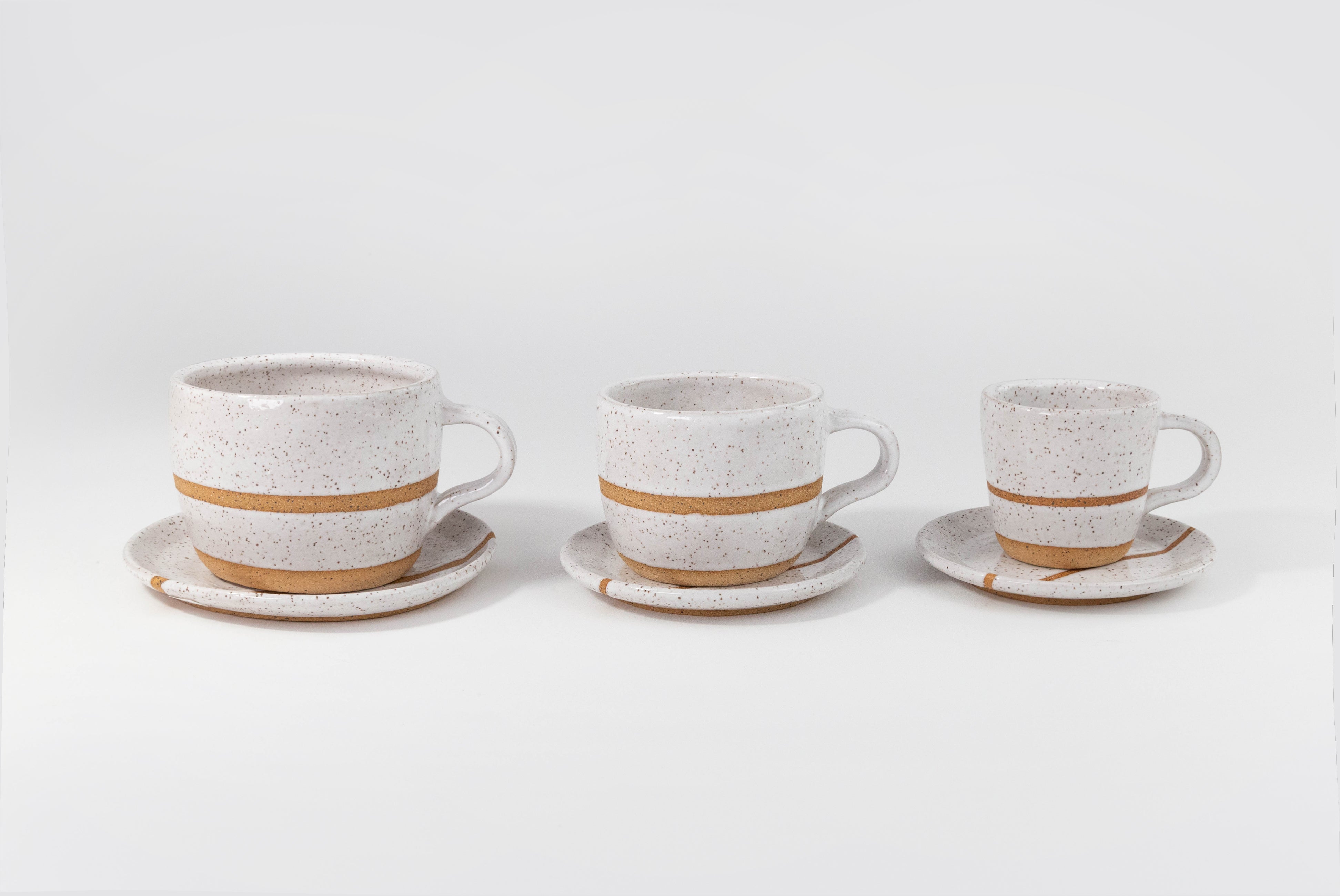 Fred James Pottery white espresso cappuccino latte coffee cup with saucer dish shown in three sizes on white background