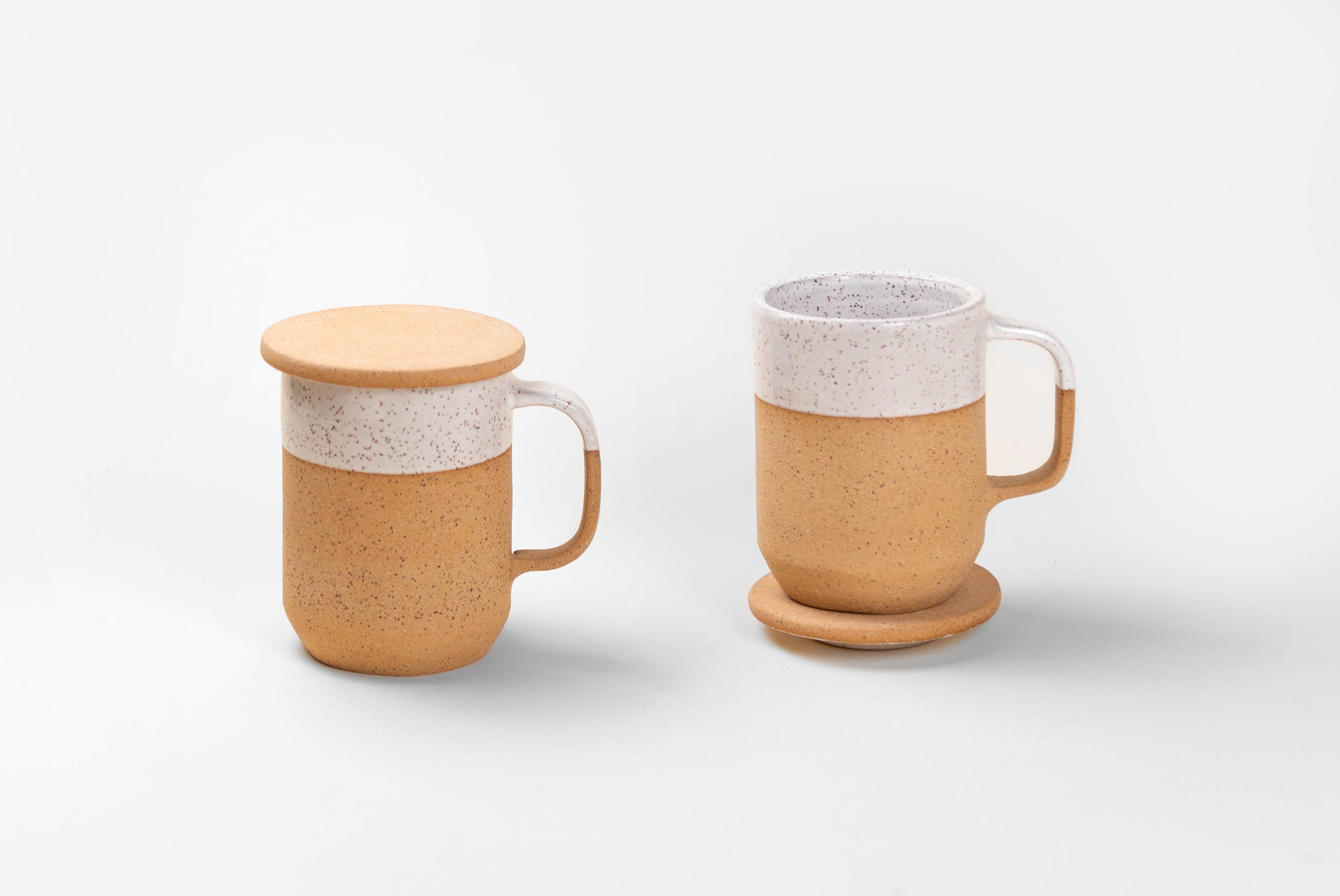 Two Tea Mugs with Lid in natural textured clay with speckled matte white glaze on top half, shown with lids on and off on white background