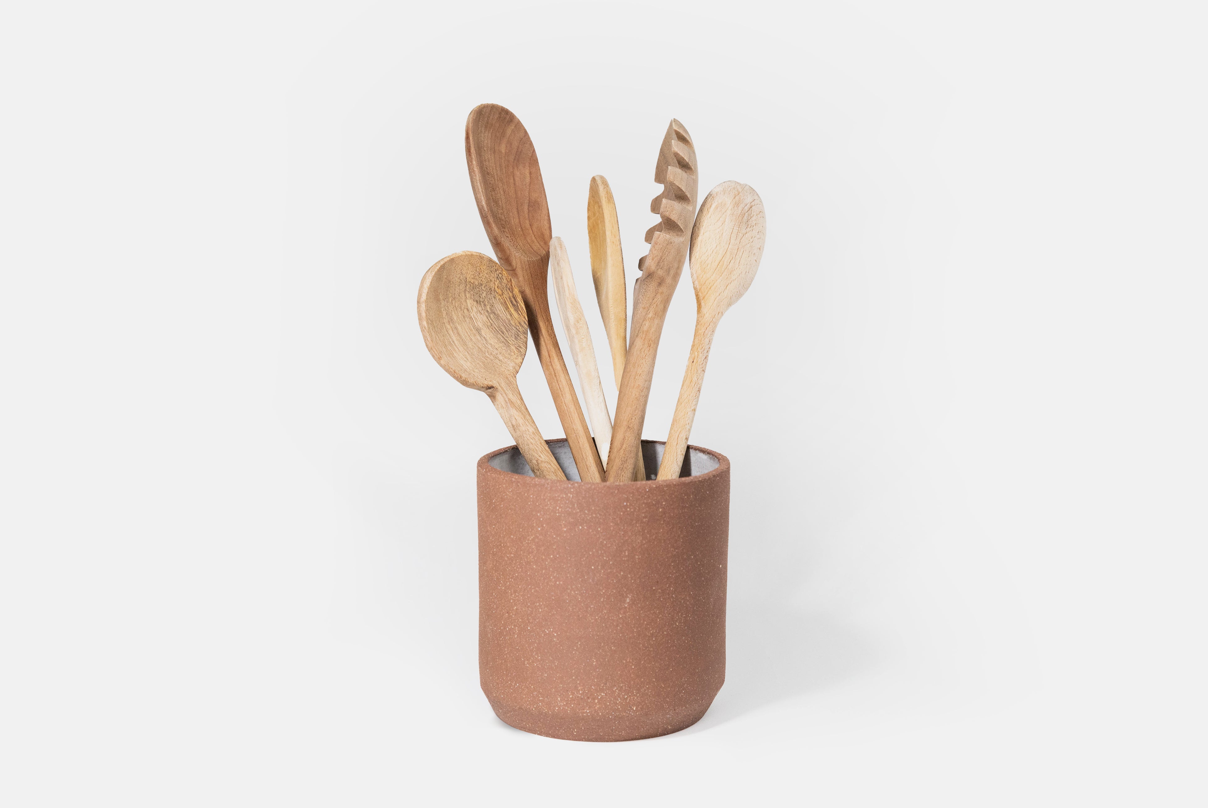 Ceramic Utensil Holder by Fred James Pottery shown with wooden utensils on white background