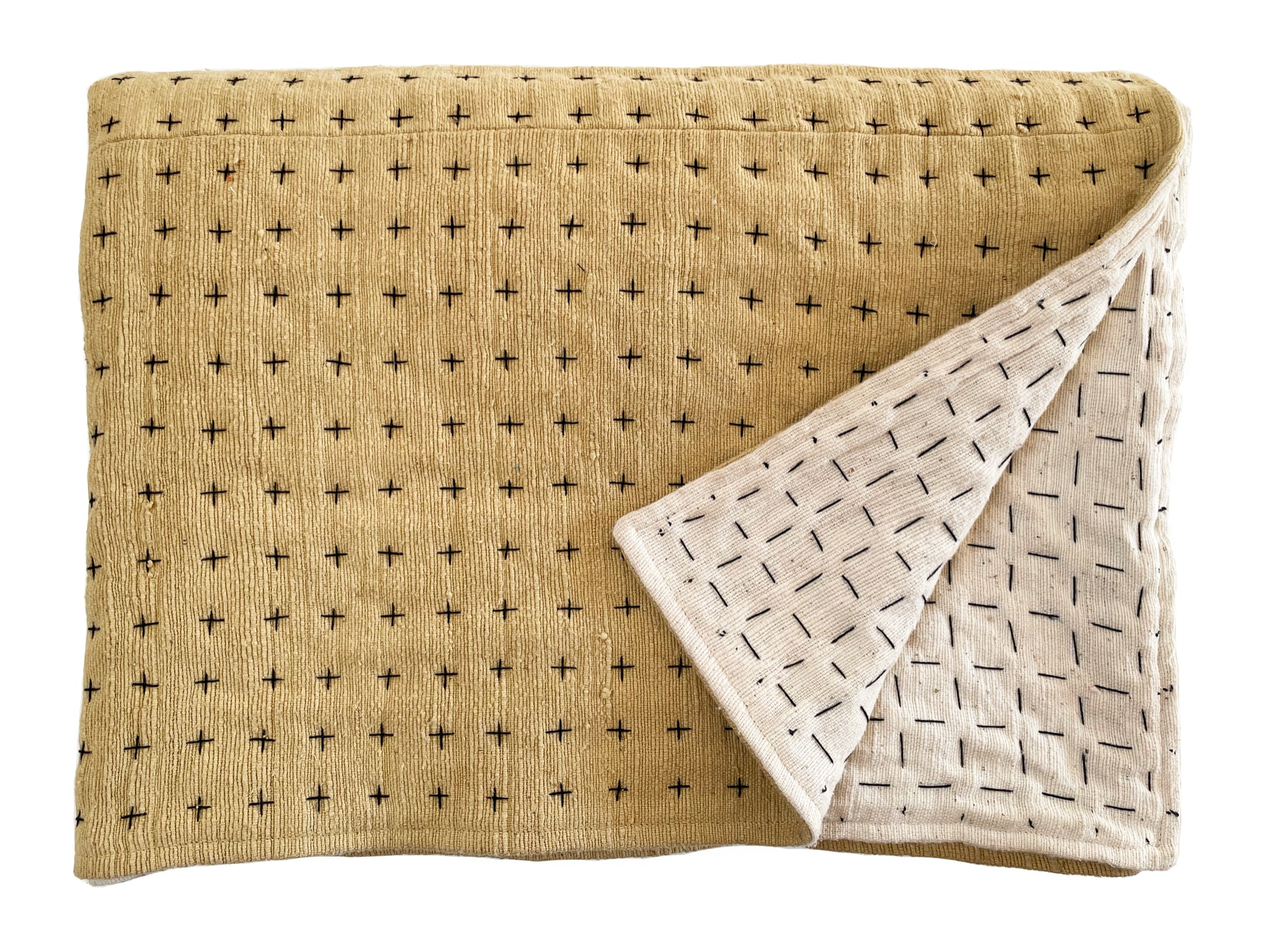 Handmade blanket by Happy French Gang, shown folded in mustard and natural color with corner folded up, on white background