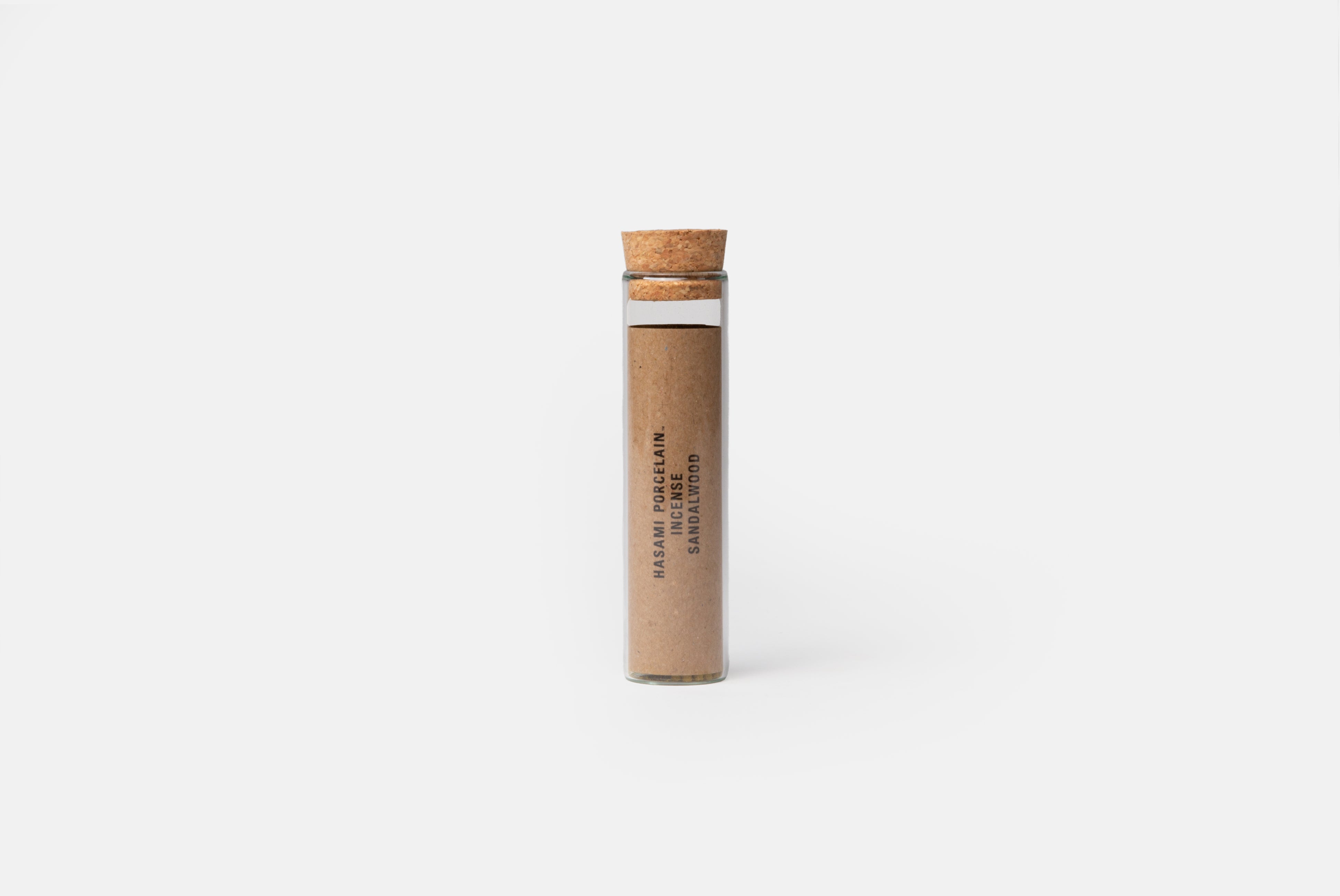 Hasami Porcelain Incense in Sandalwood shown in glass packaging with cork