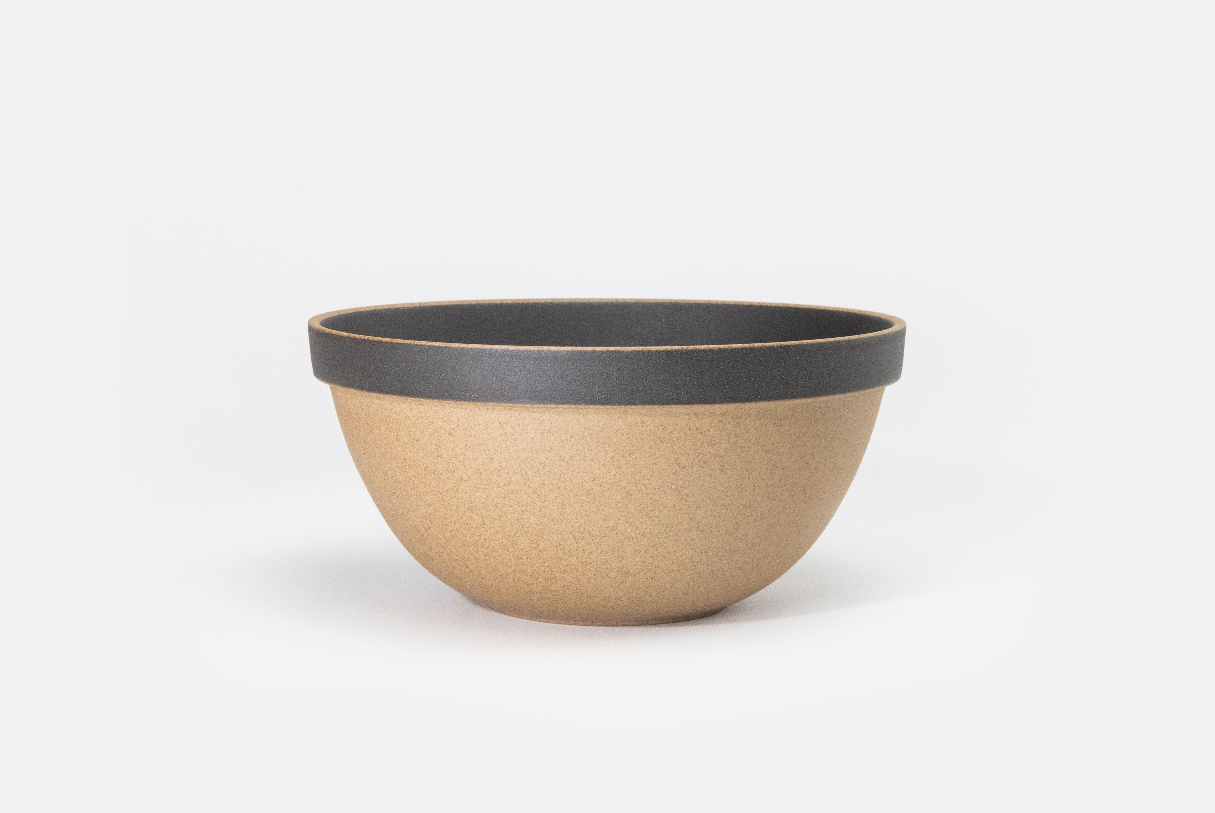 Hasami Porcelain Round Bowl in natural with matte black rim and inside on white background