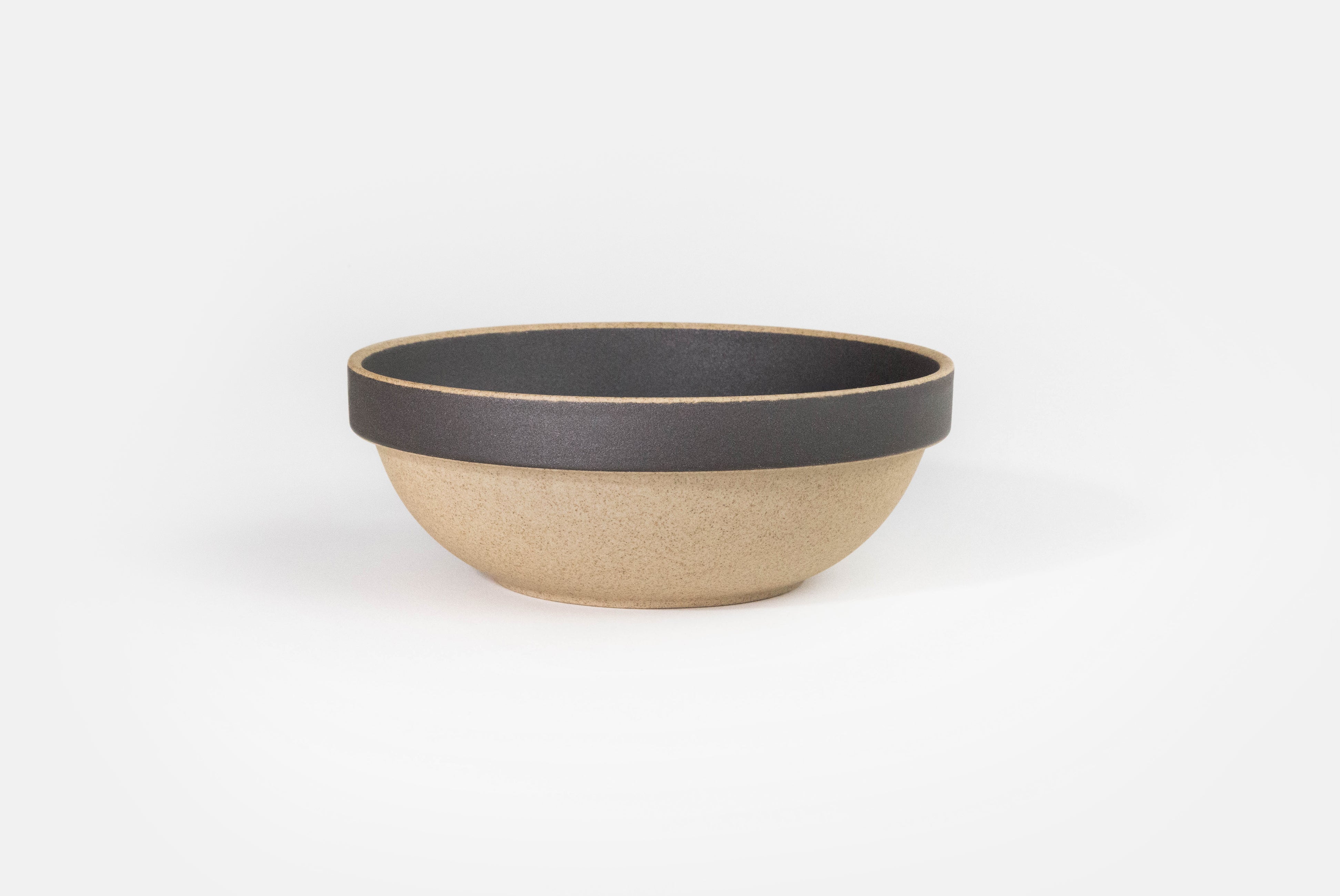 Hasami Porcelain Small Round Bowl in natural with matte black rim and inside on white background