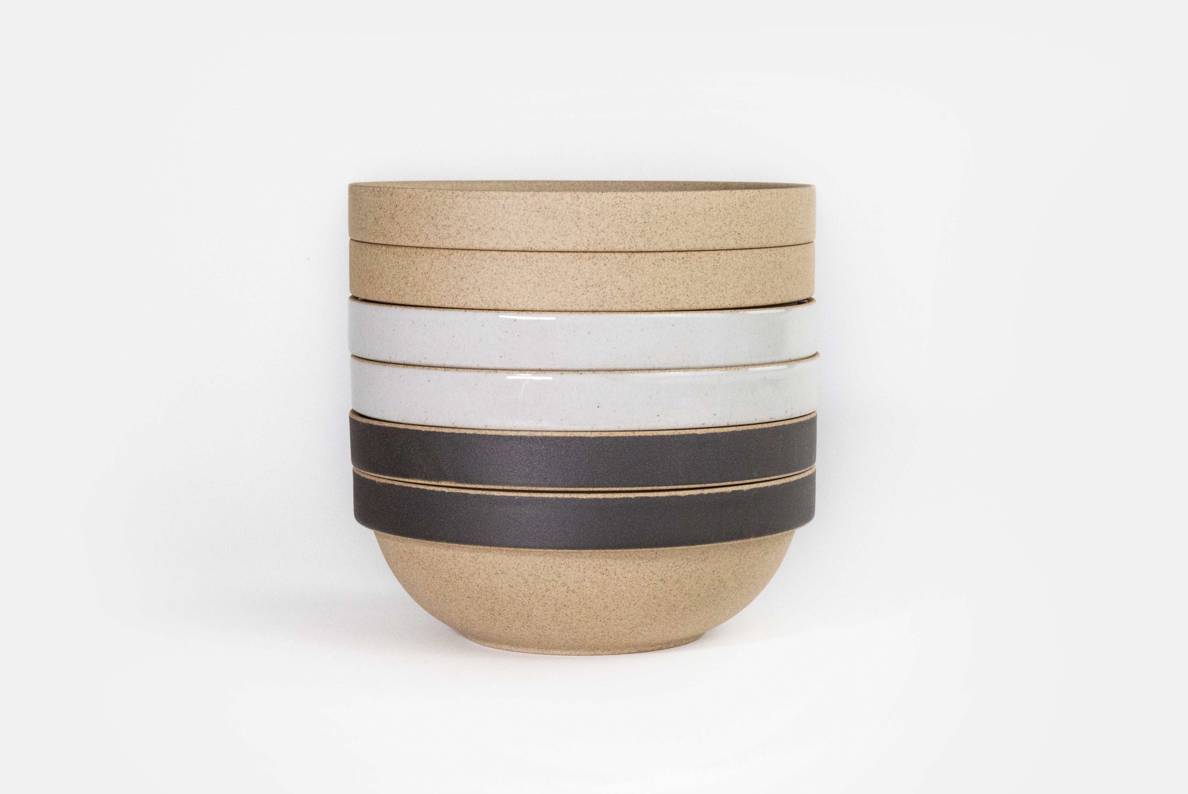 Hasami Porcelain Small Round Bowl in gloss gray, natural, and natural with matte black in a stack of six on white background