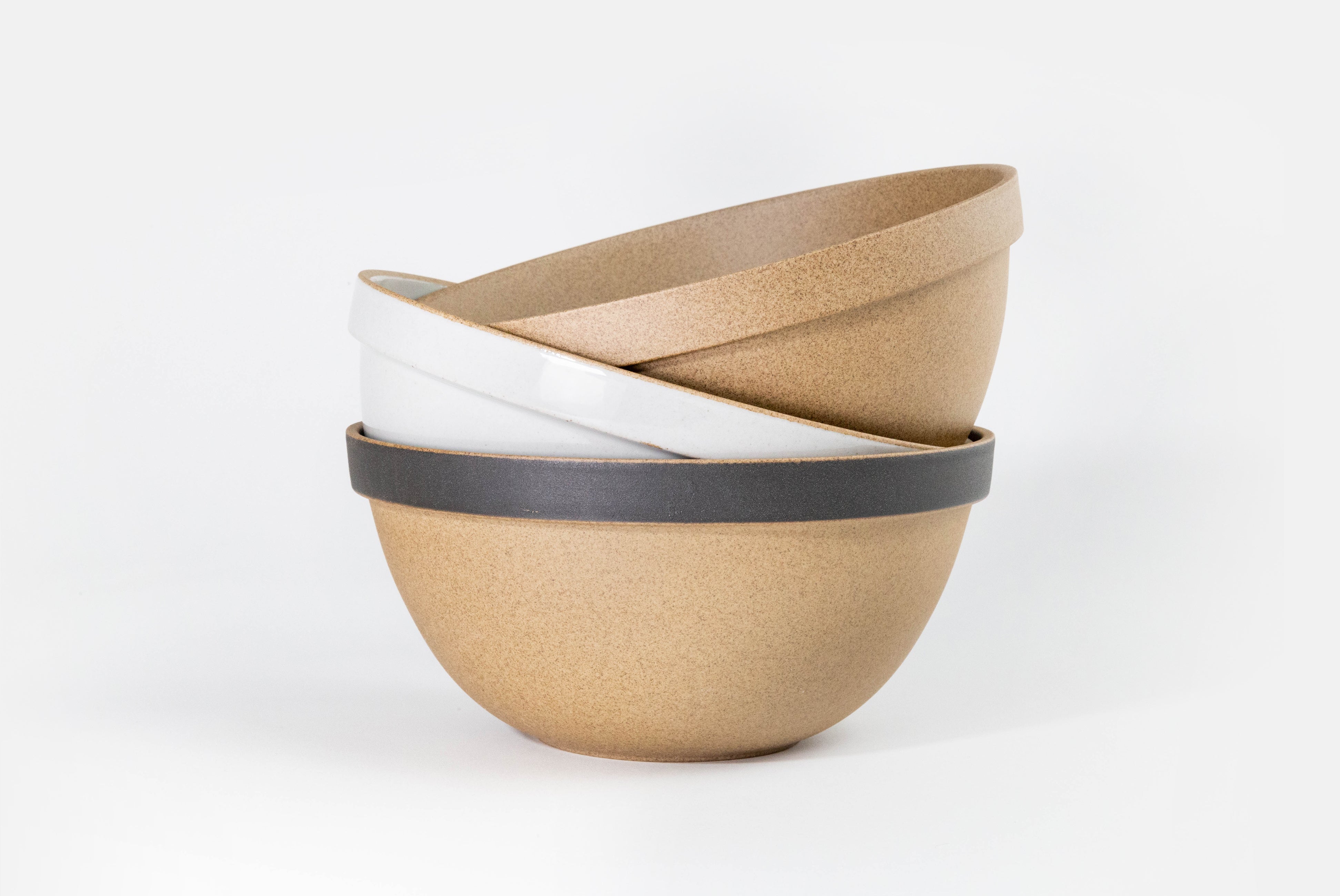Hasami Porcelain Round Bowl in gloss gray, natural, and natural with matte black in a haphazard stack of three on white background