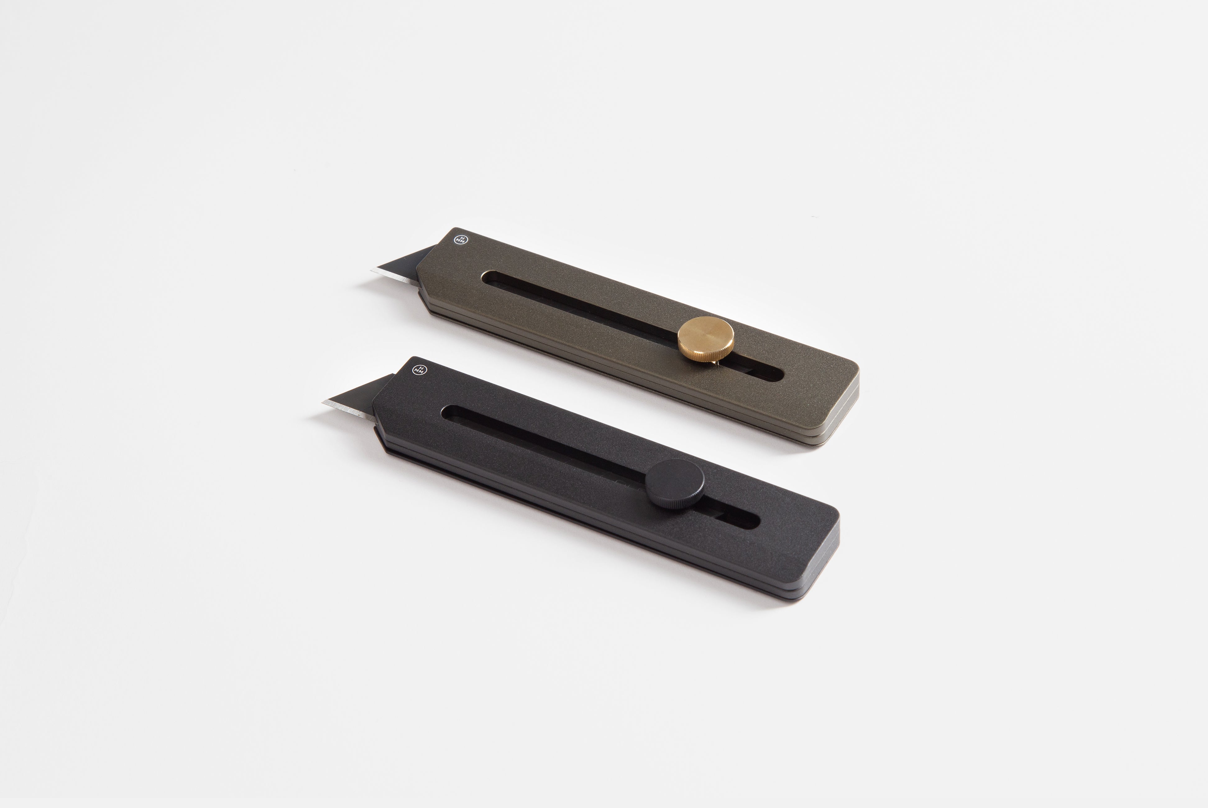 Utility Knife by Hmm, shown in both black and green colors, on white background