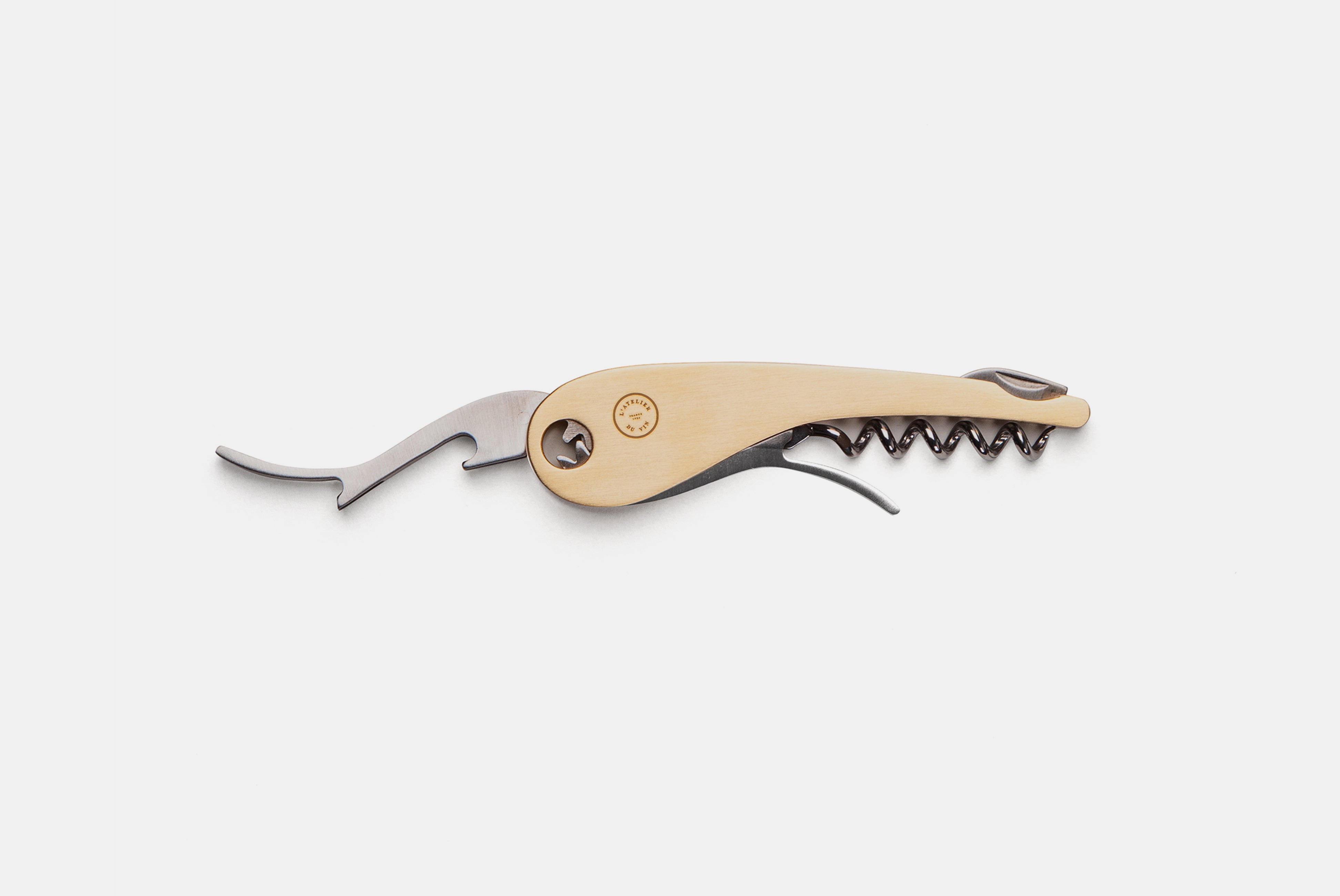 L’Atelier du Vin shown on white background with bottle opener extended
