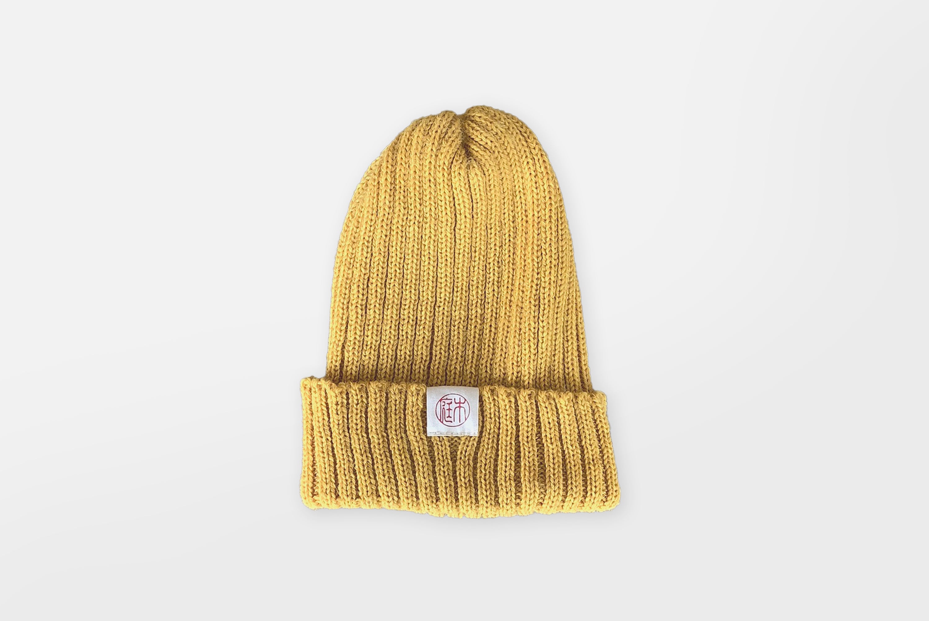 Niwaki Wool Knit Hat in mustard yellow color shown flat on white background