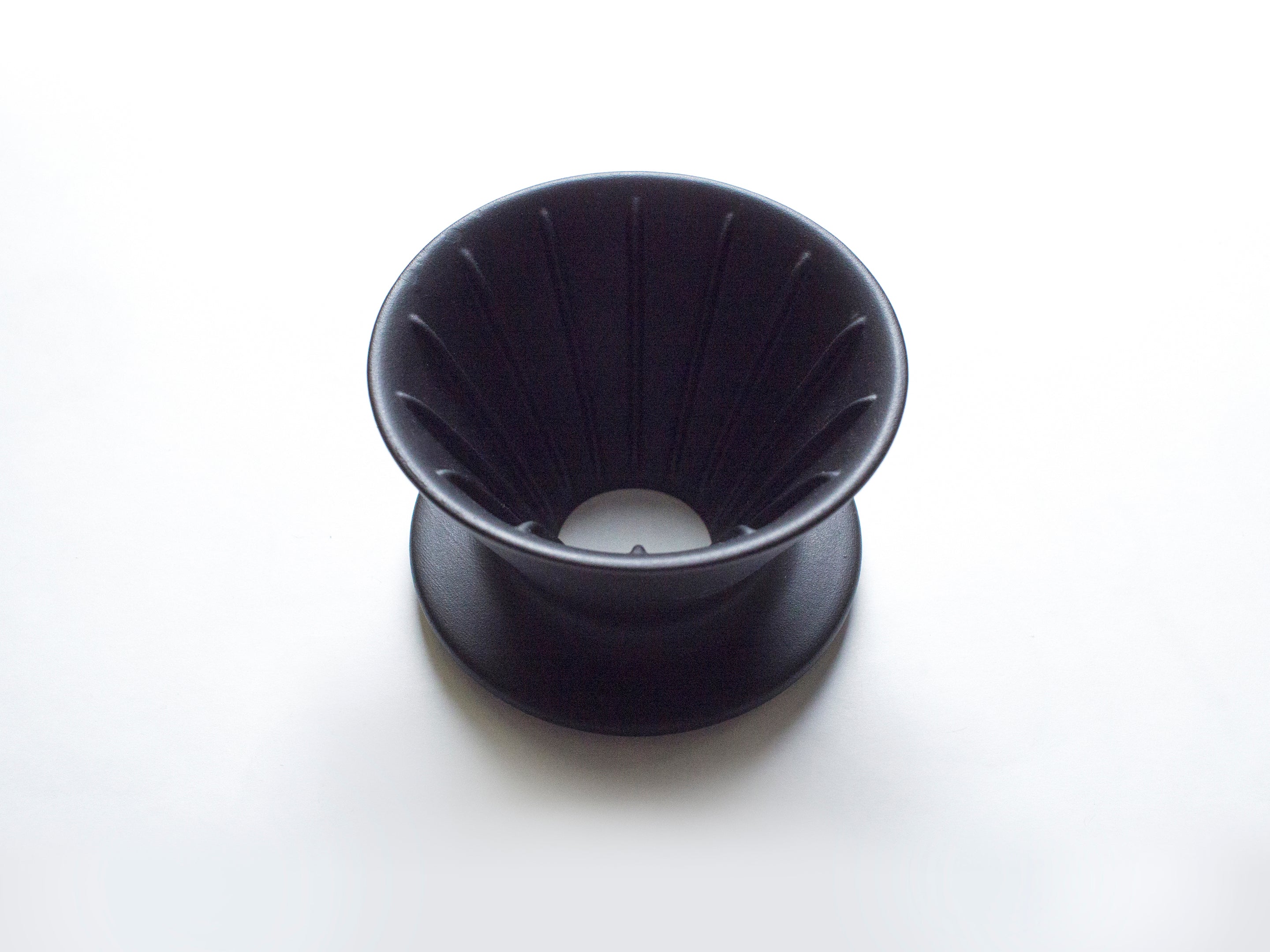 Patio Ceramic Coffee Dripper by HMM in matte black, shown from top at angle, on white background