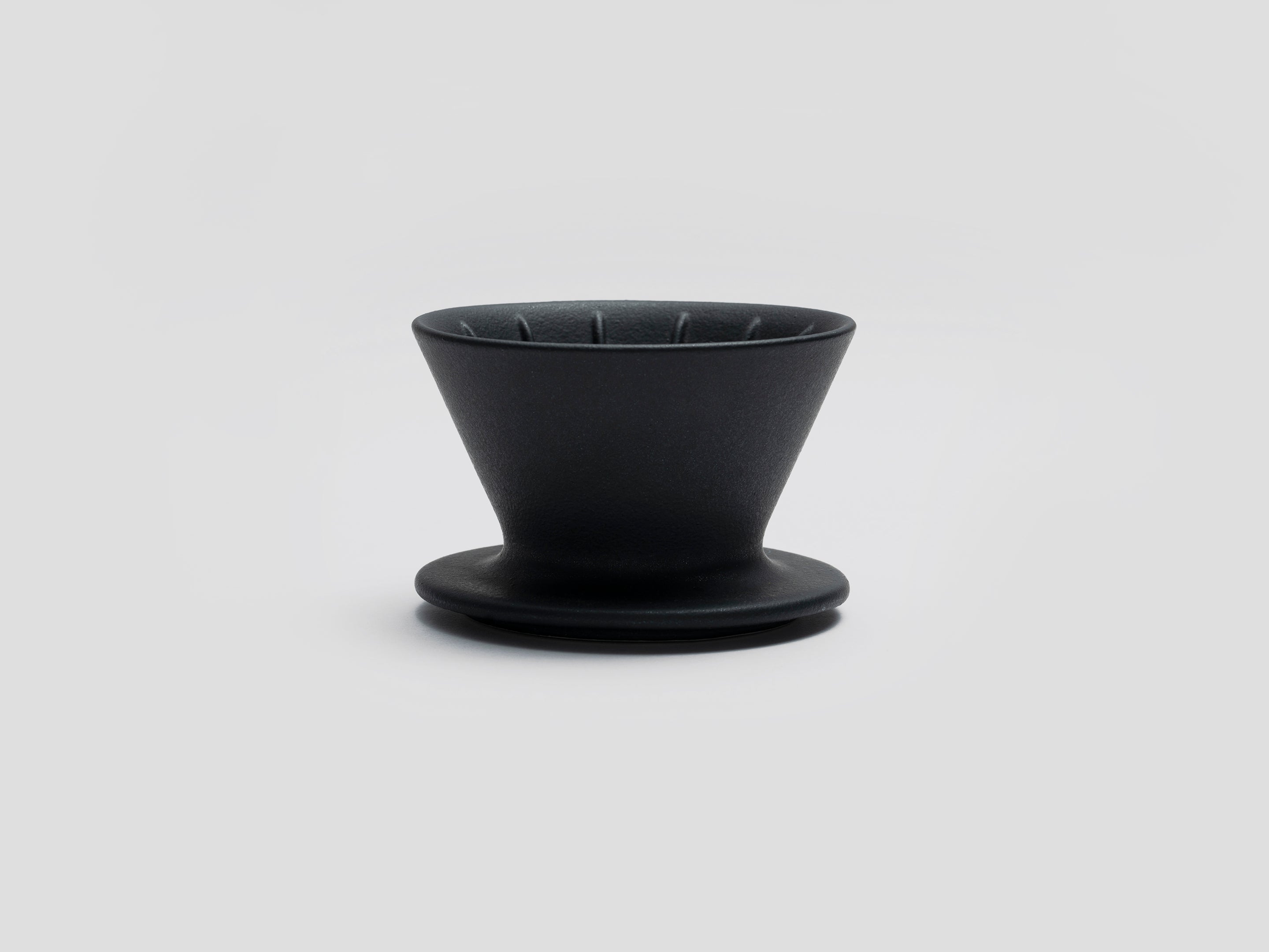 Patio Ceramic Coffee Dripper by HMM in matte black, shown from front profile, on white background