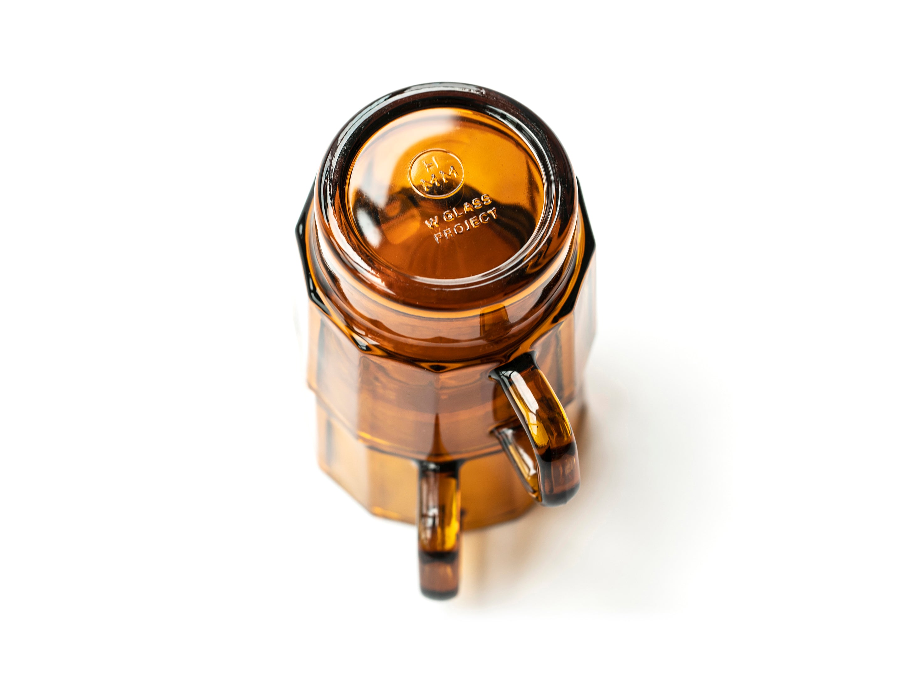 W Glass by HMM shown as a pair in amber color, stacked upside down on white background