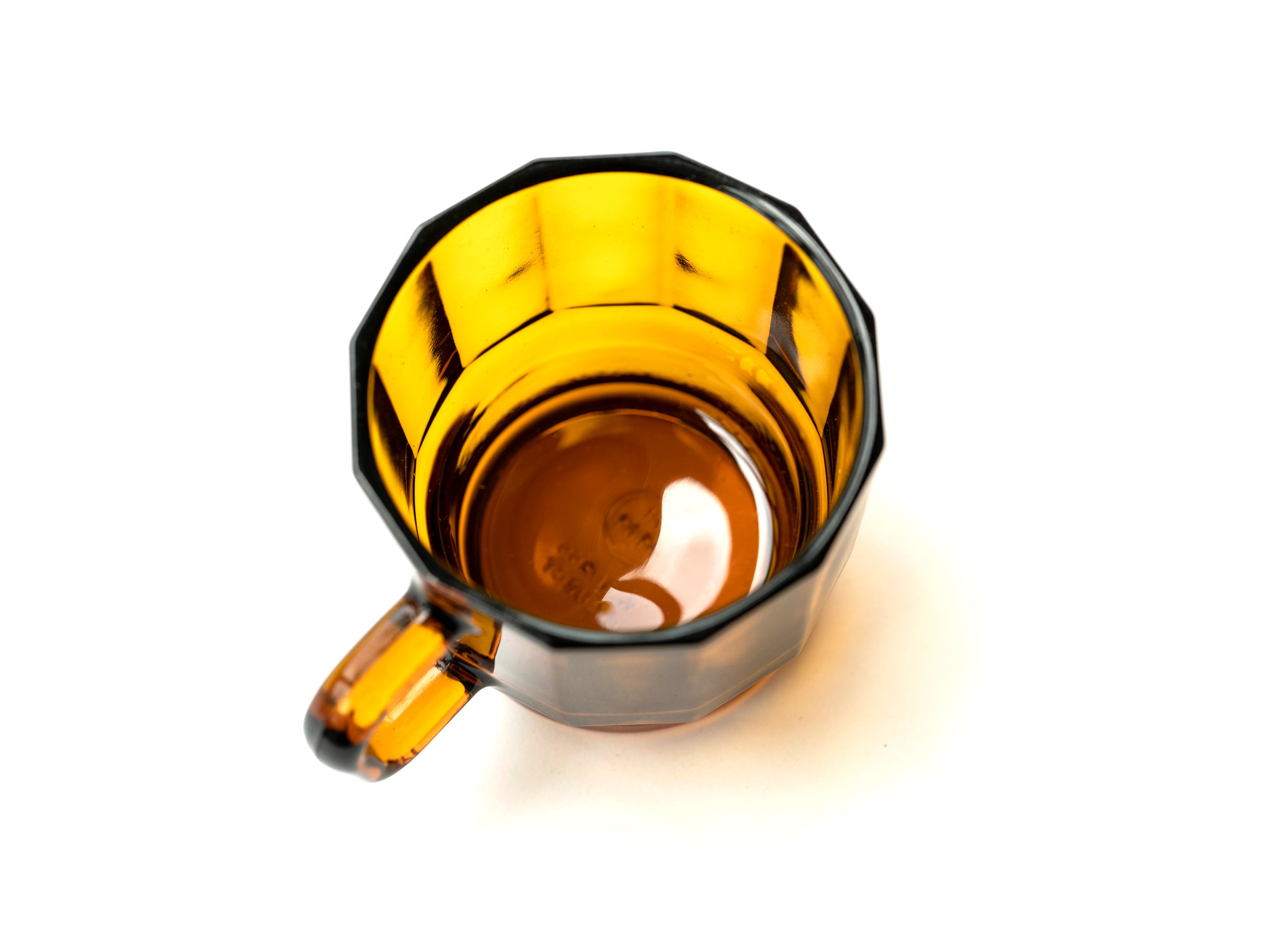 W Glass by HMM shown in amber, from above, on white background