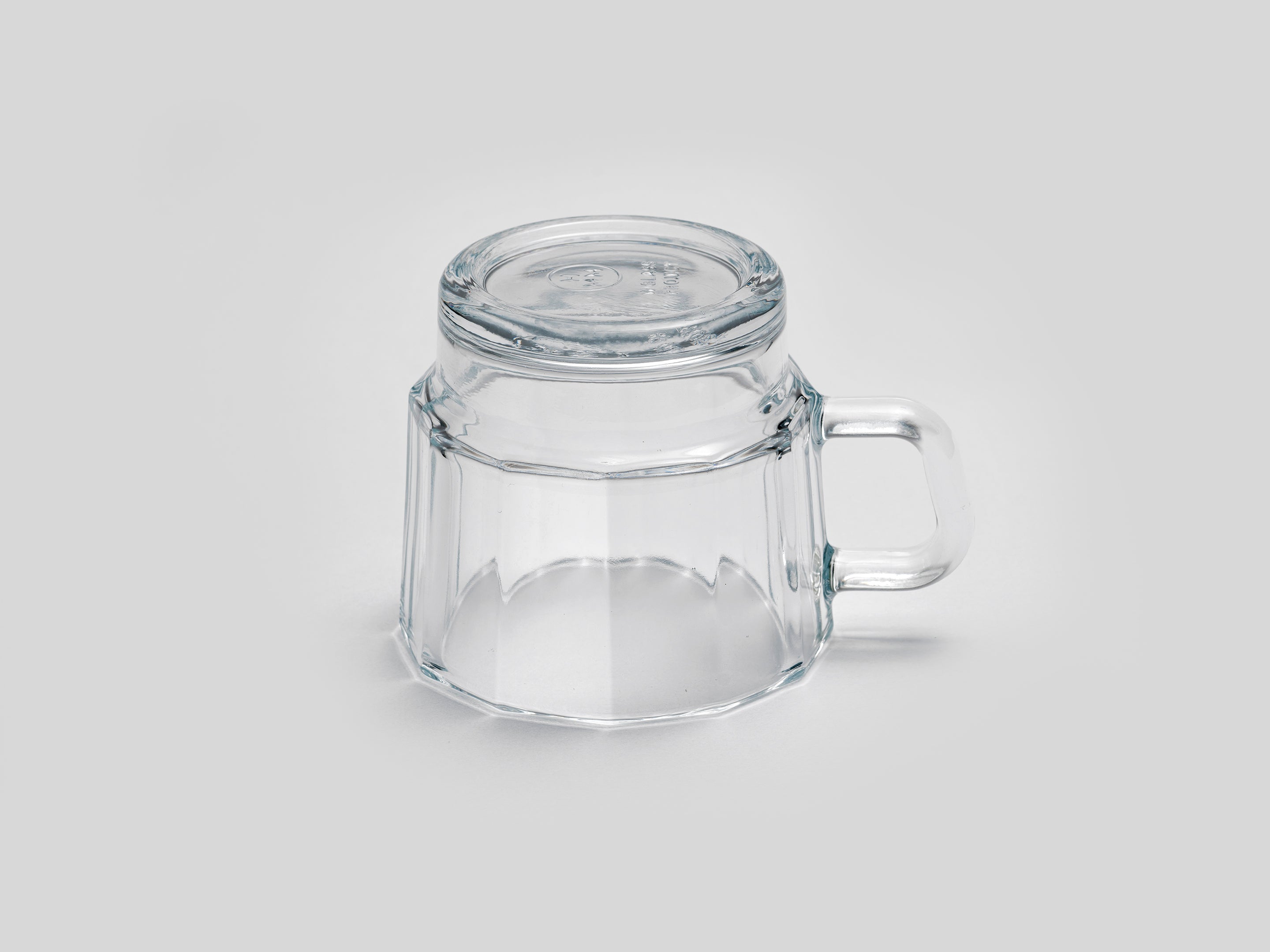 W Glass by HMM shown in clear, from side profile, upside down, on white background