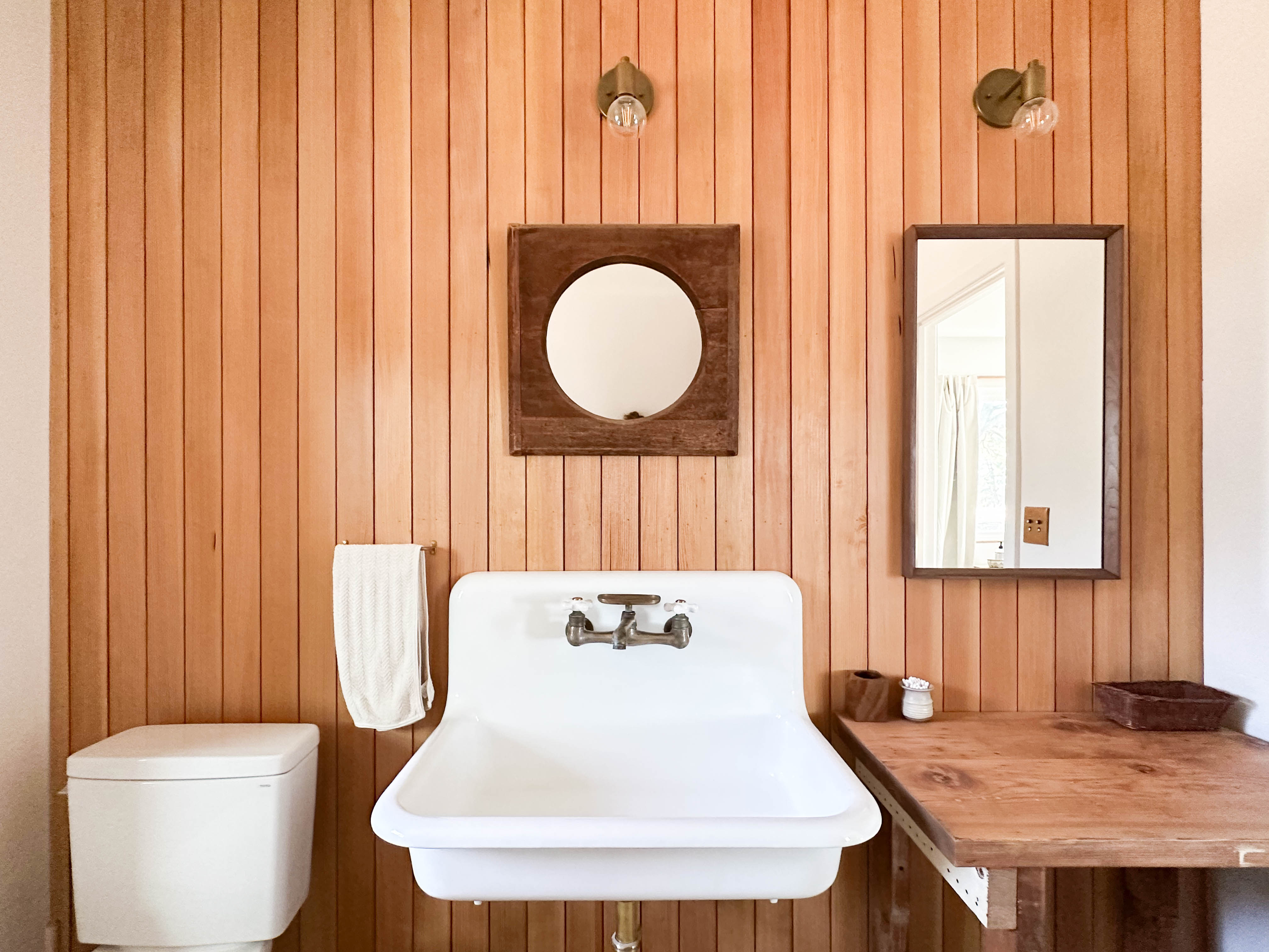The sink and wood panel wall in the bathroom of the master bedroom at Campover Ranch in Paso Robles, California