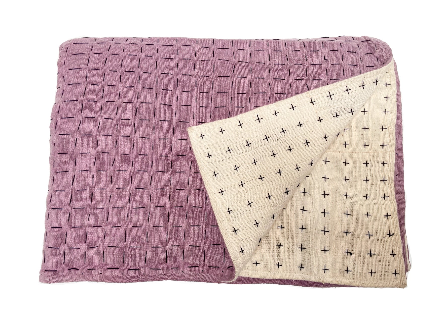 Handmade blanket by Happy French Gang, shown folded in lavender and white color with corner folded up, on white background