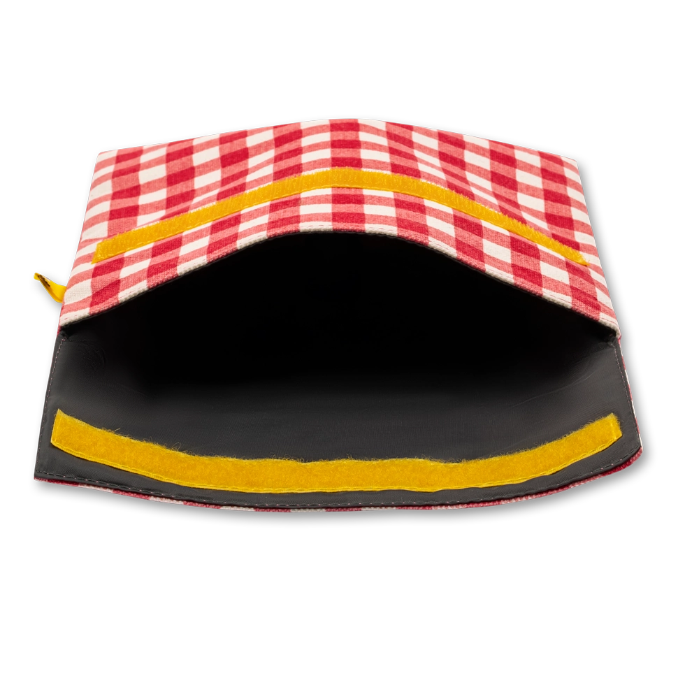 Flip Reusable Snack Bag shown in red gingham laying on side open from top