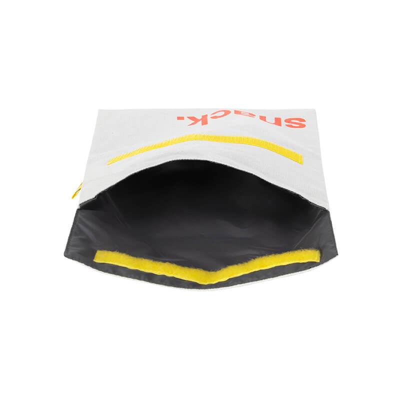 Flip Reusable Snack Bag shown in "Snack" Orange laying on side open from top