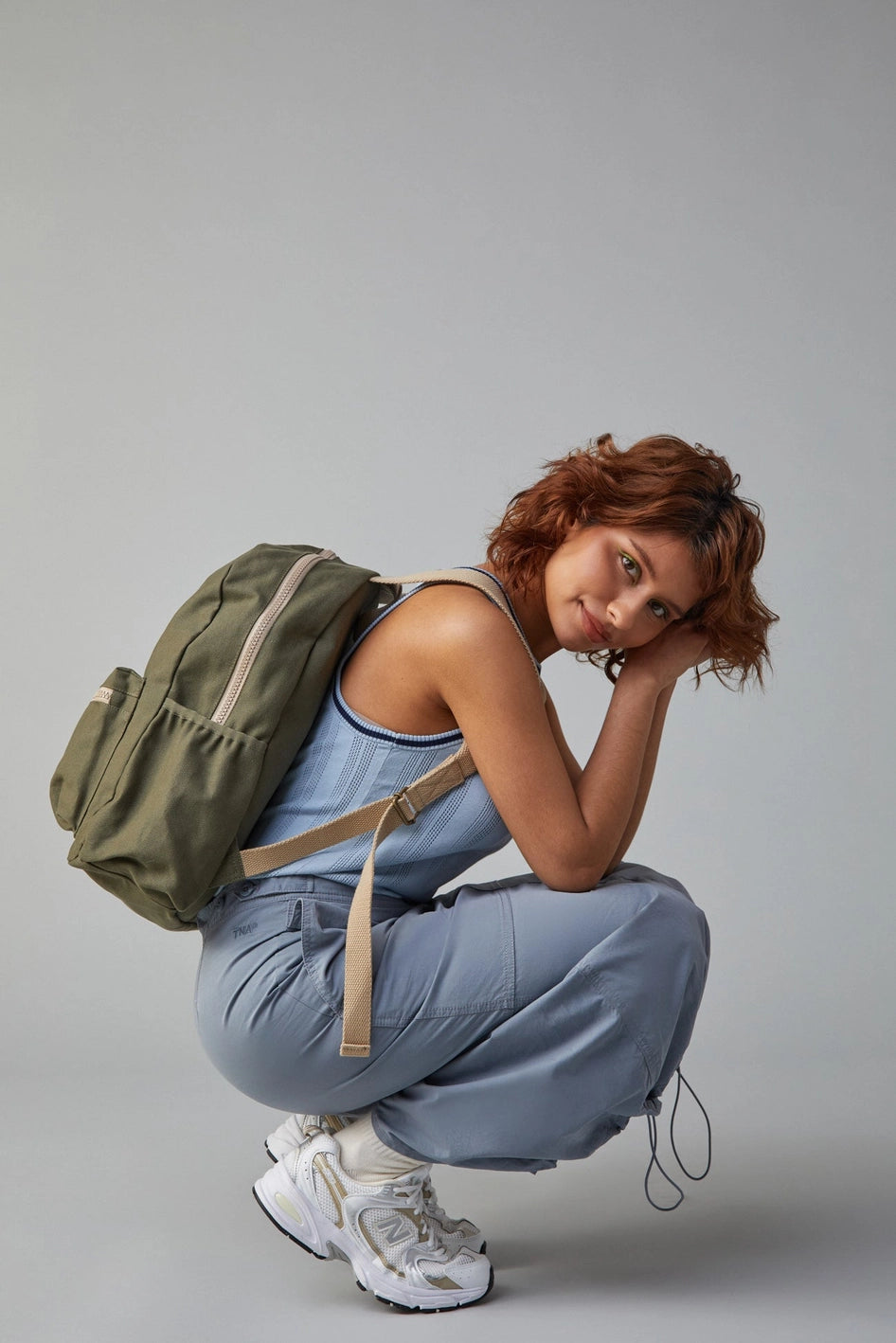 Fluf Organic B Pack Backpack shown in Dark Olive side view worn by person