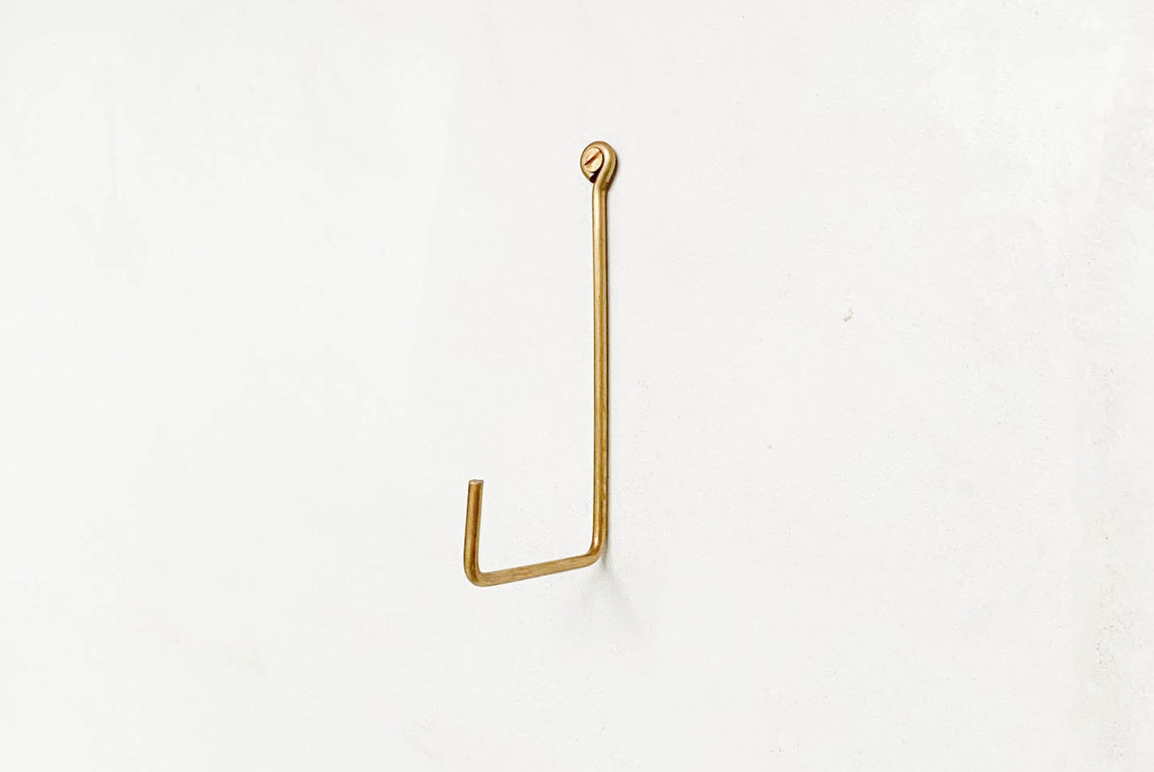 Fog Linen Thin Brass Hook shown on wall | product detail