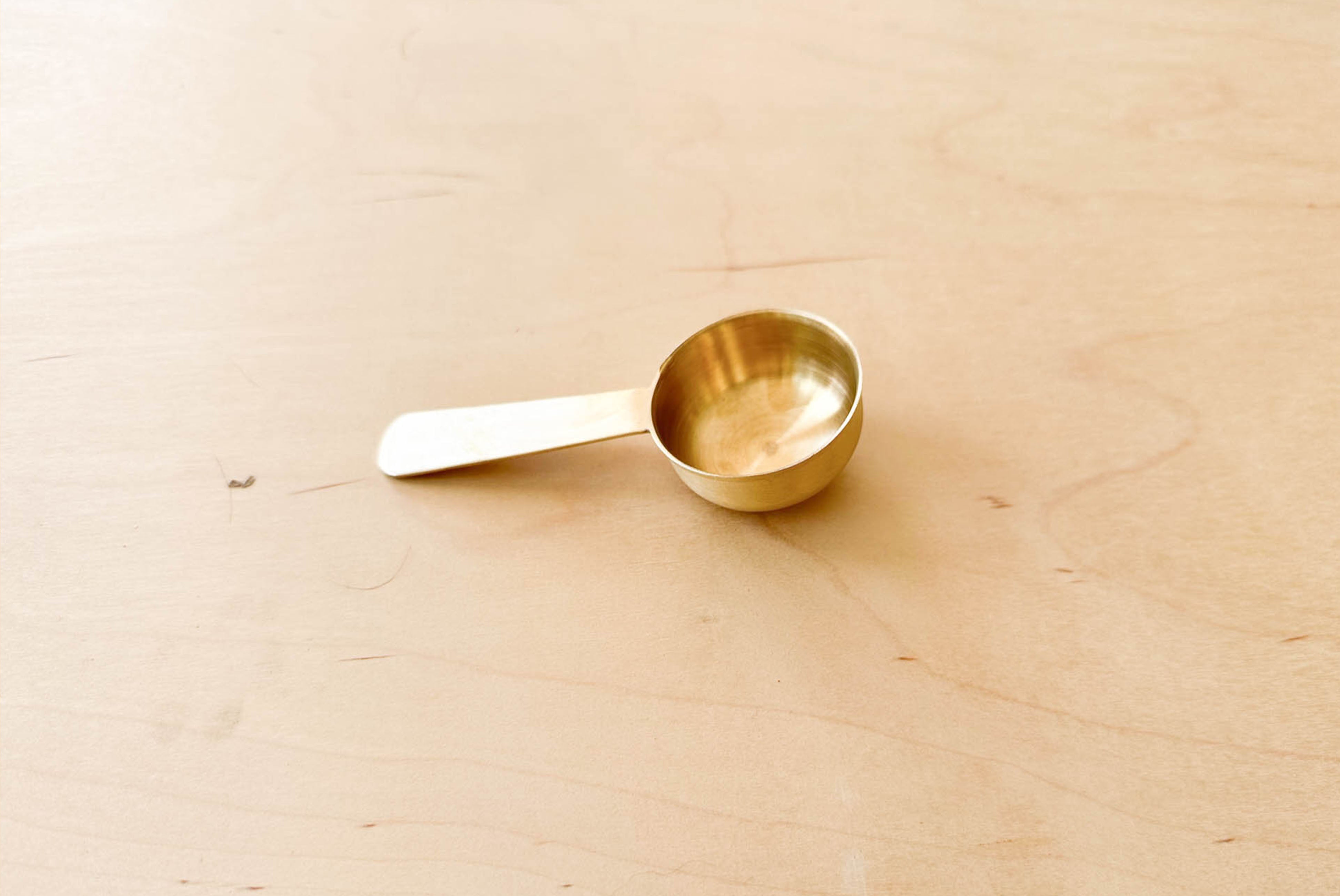 Fog Linen Brass Scoop close up on wood surface