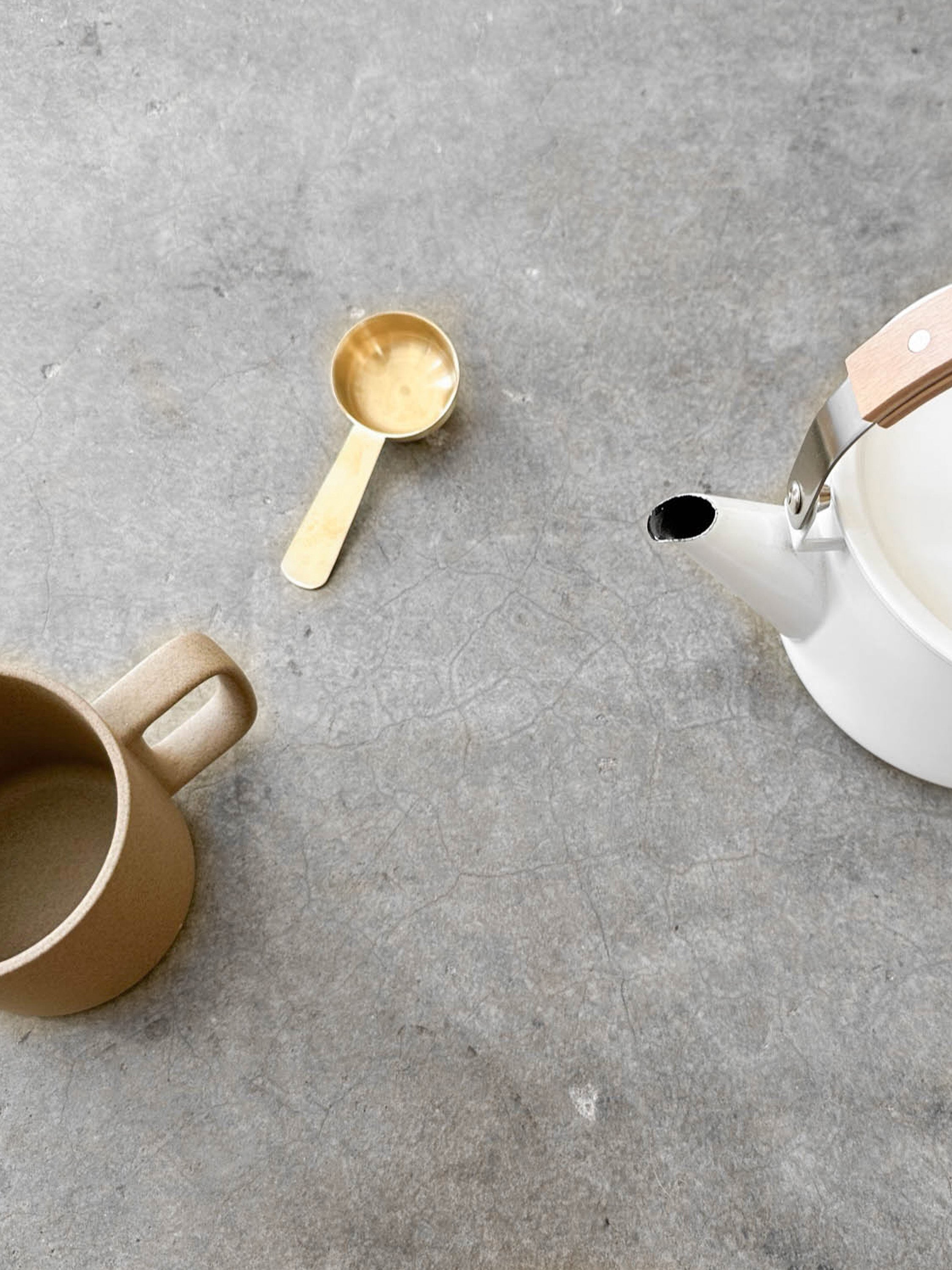 Fog Linen Brass Scoop on concrete countertop