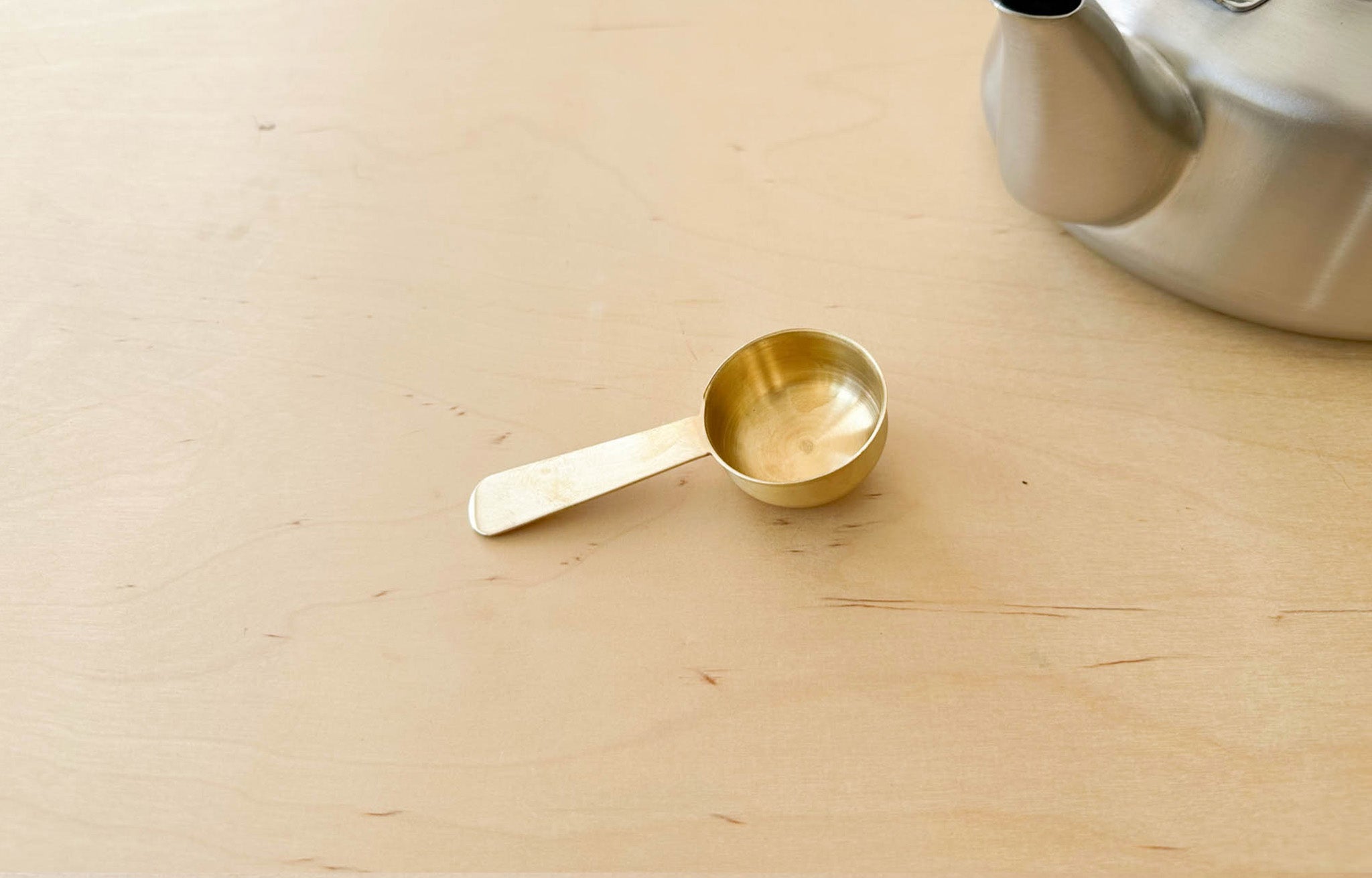 Fog Linen Brass Scoop with Japanese Stainless Steel Kettle on wood surface