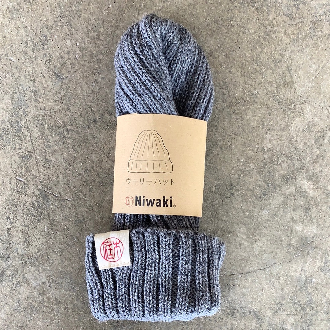 Niwaki Wool Knit Hat in grey gray color shown with packaging on gray background. Fisherman style beanie.