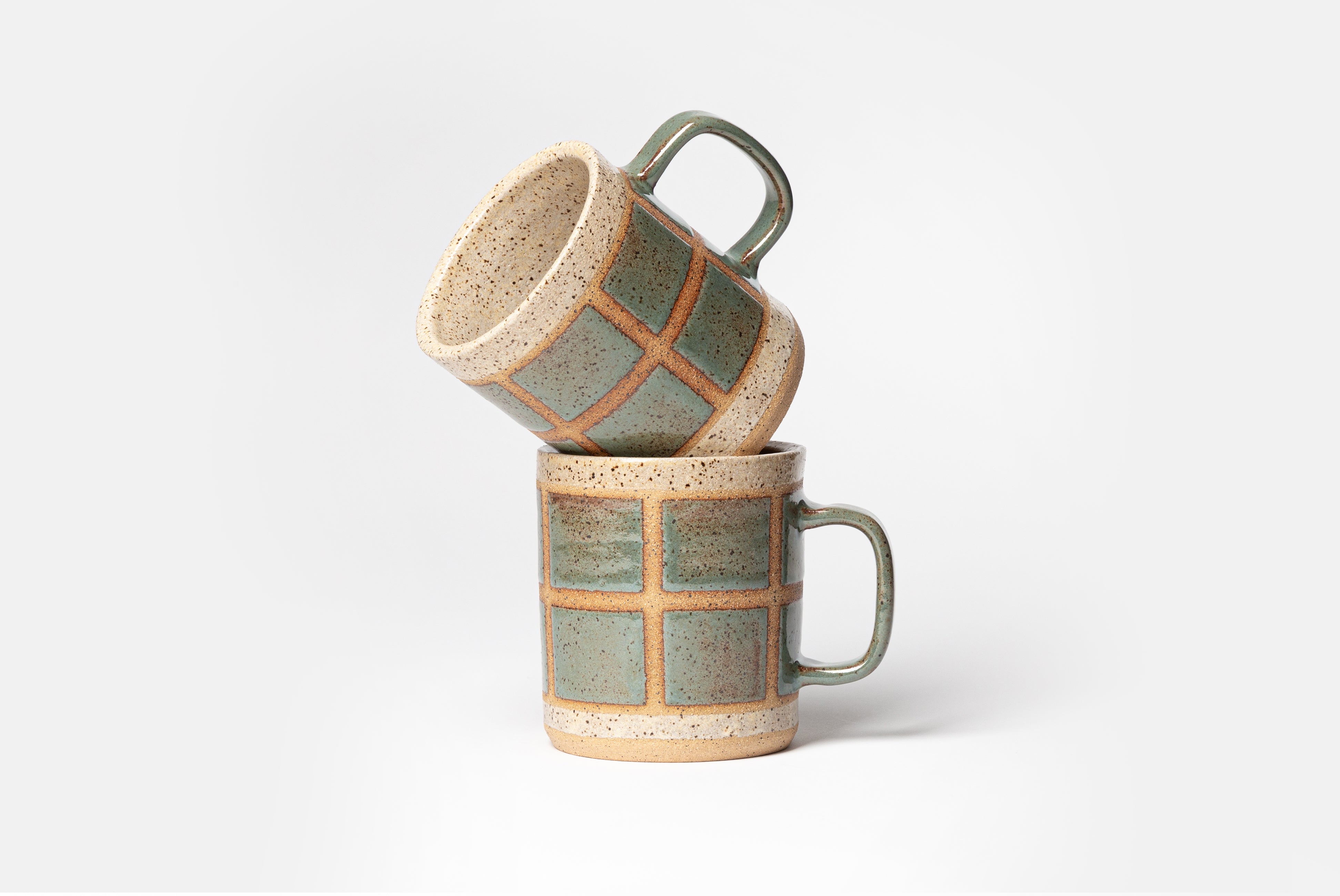 Two Ceramic Camp Mugs by Campover in collaboration with Fred James Pottery, shown in a crooked stack, on white background