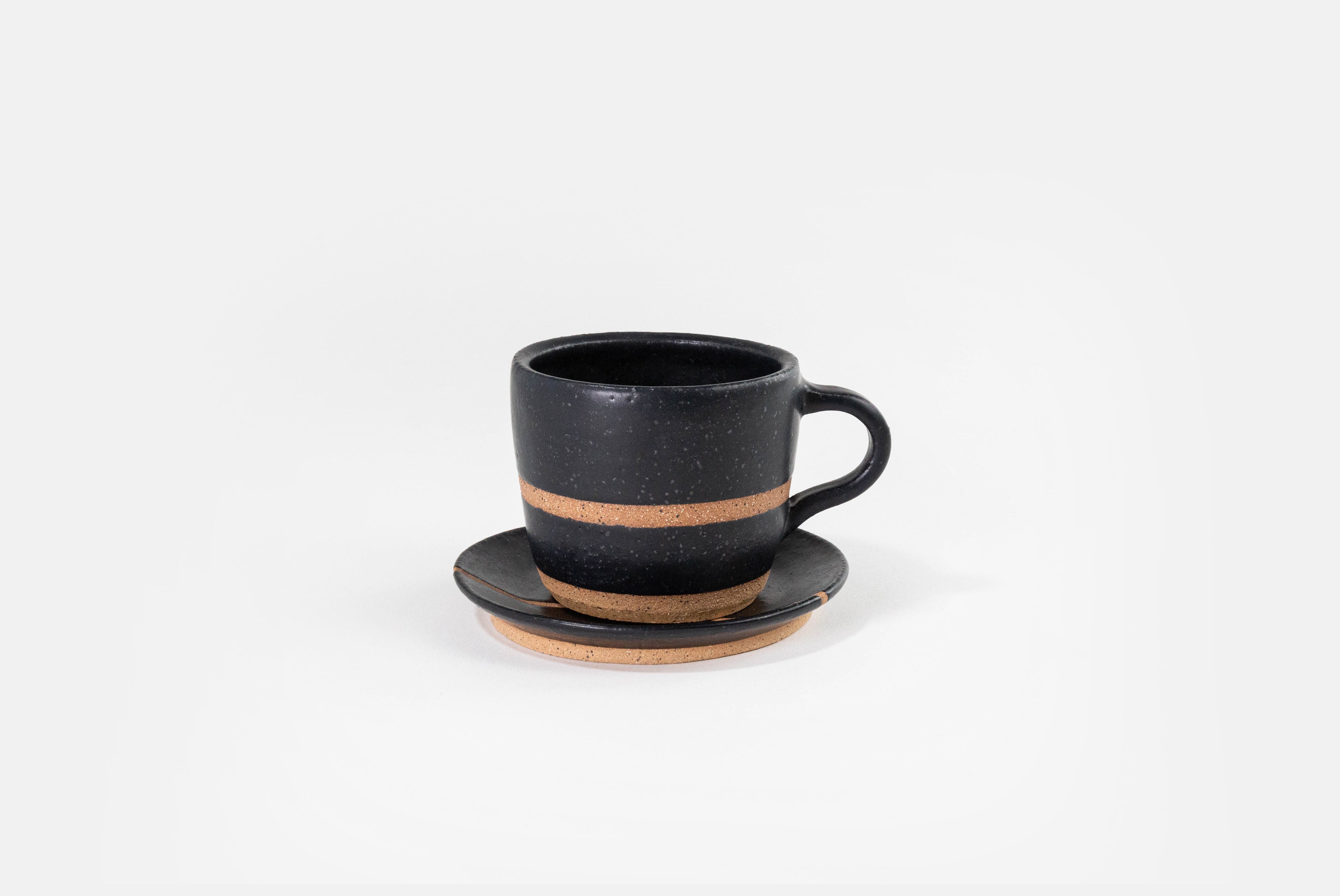 Fred James Pottery matte black cappuccino cup with saucer dish shown on white background