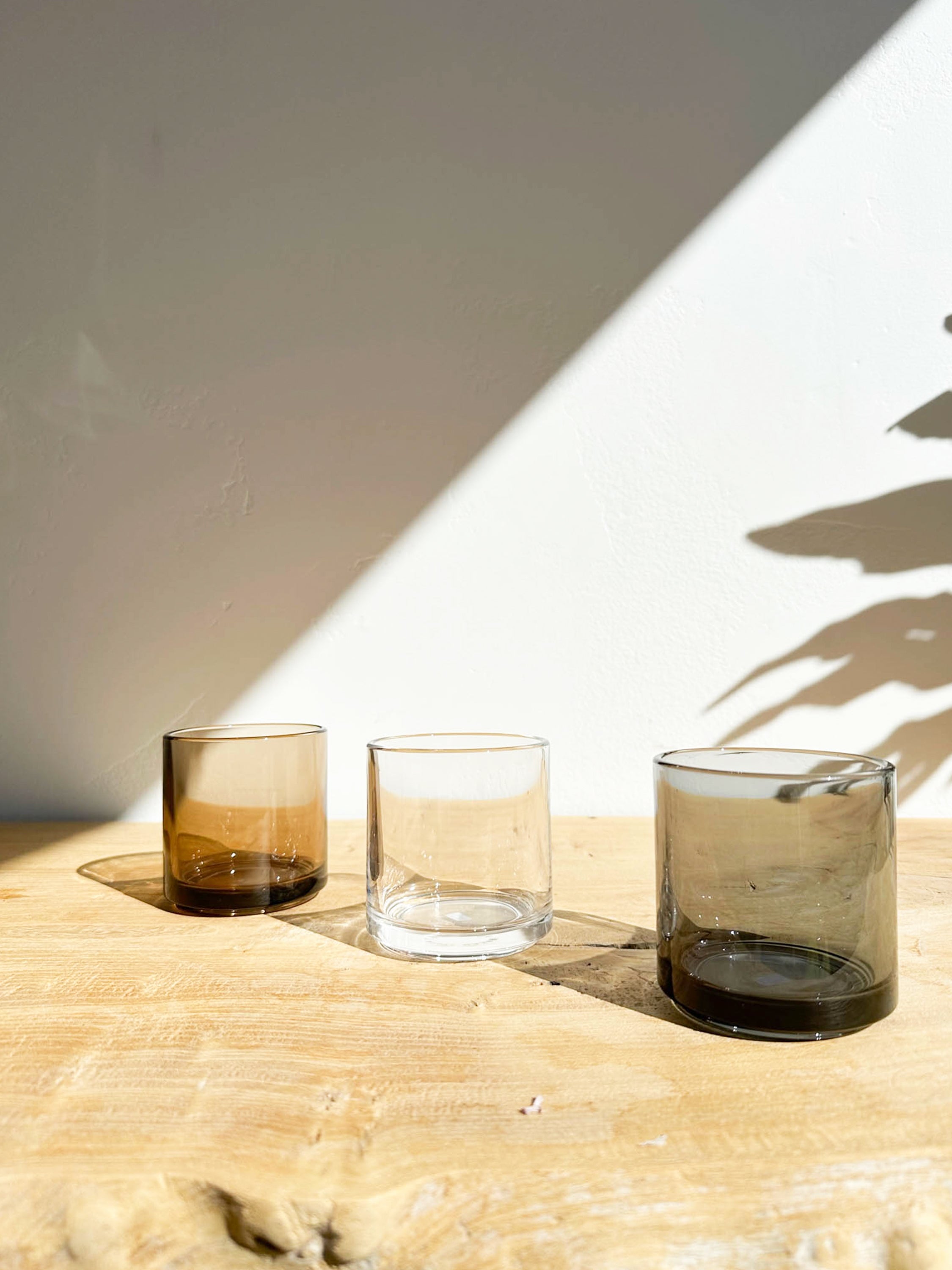 Hasami Glass Tumbler shown in all three colors: amber, clear, and smoke | lifestyle
