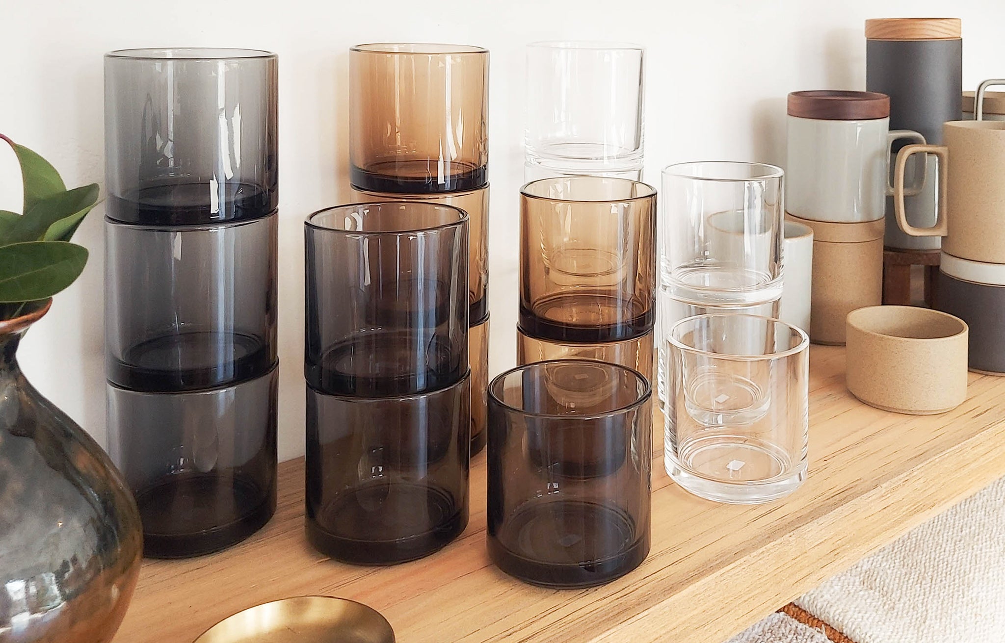 Hasami Glass Tumblers shown stacked on shelf in all colors, with the Hasami Mugs in various colors | lifestyle