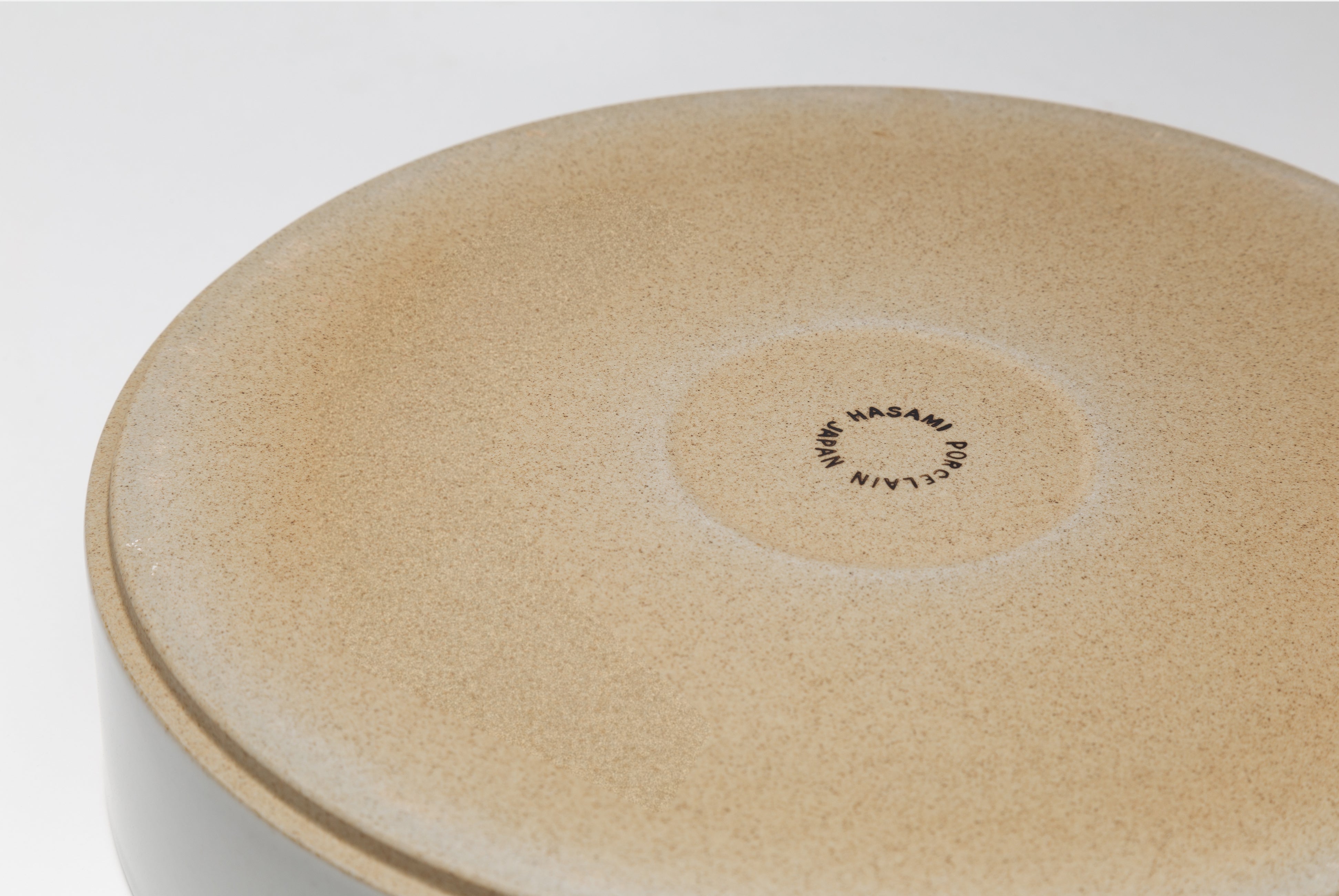 Close-up of the bottom of the Hasami Porcelain 10 inch serving bowl in Gloss Grey shown on white background