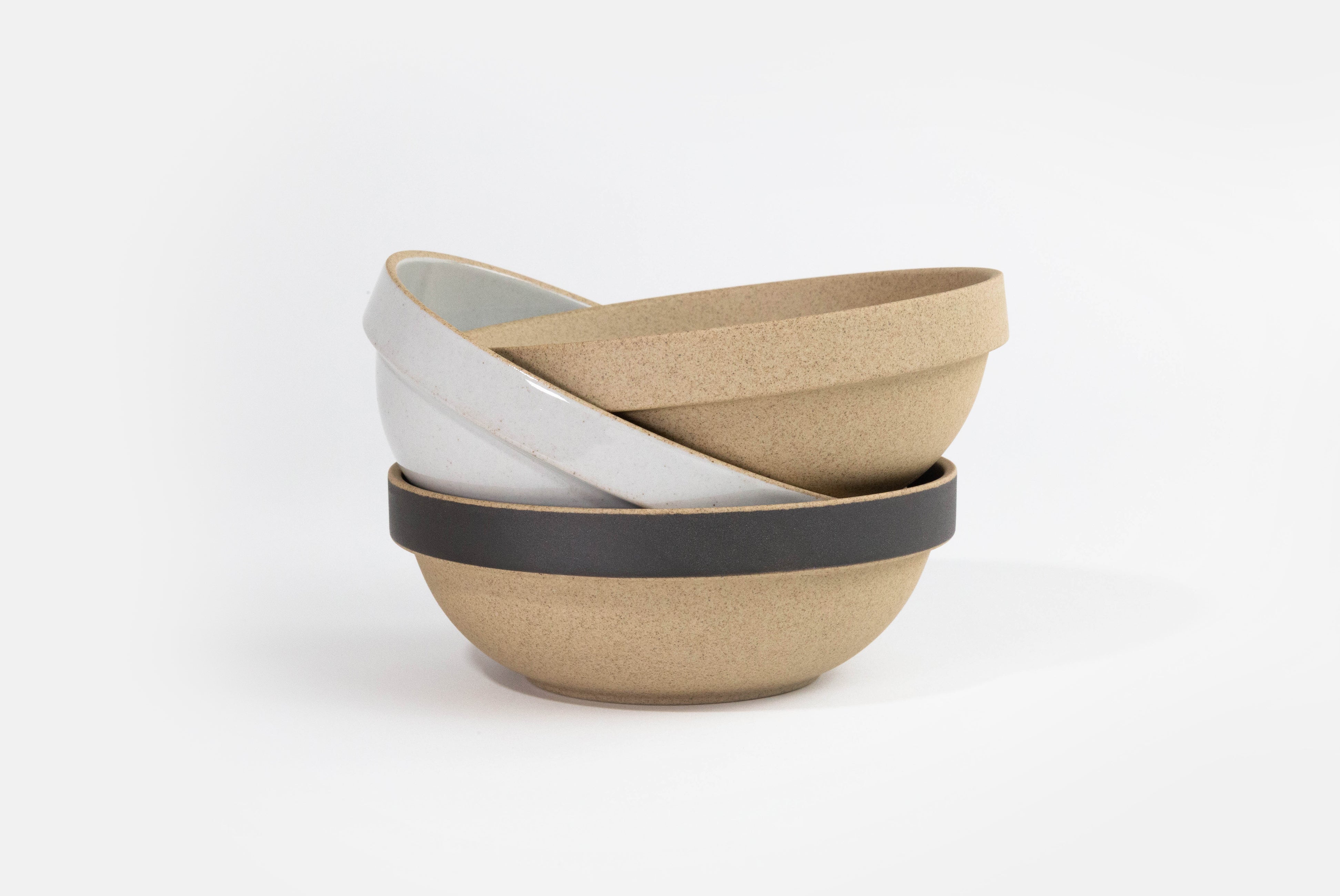 Hasami Porcelain Small Round Bowl in gloss gray, natural, and natural with matte black in a haphazard stack of three on white background