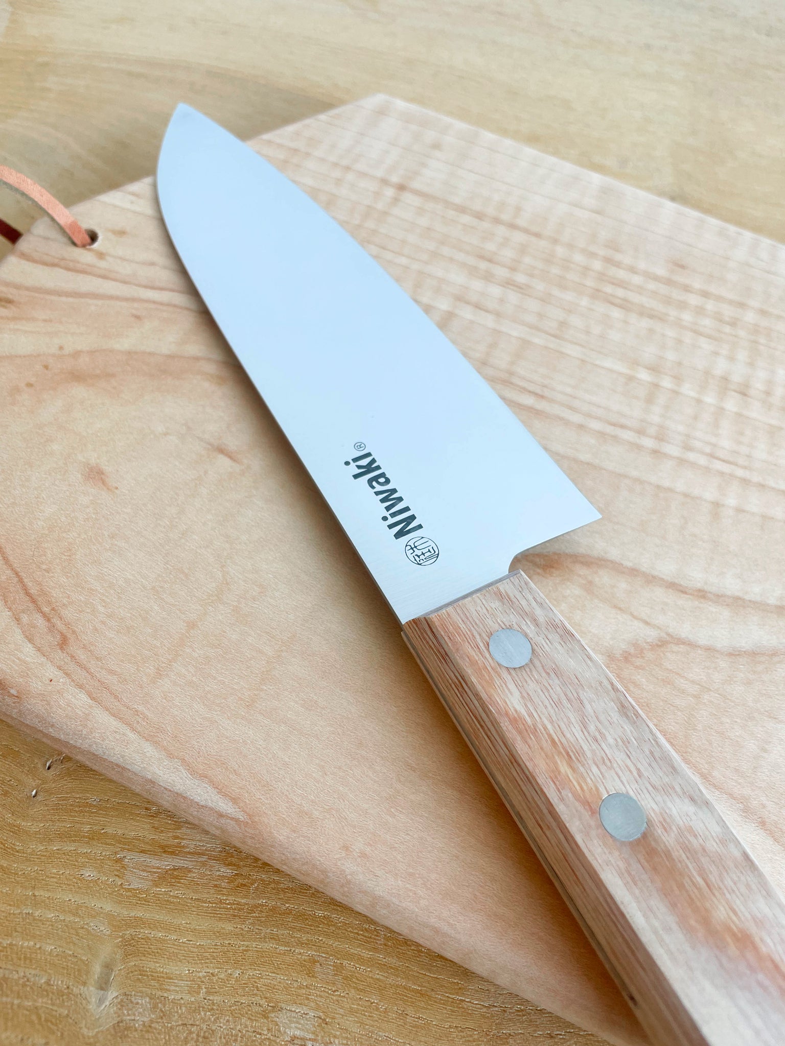 Niwaki Chef's Knife shown on cutting board | lifestyle