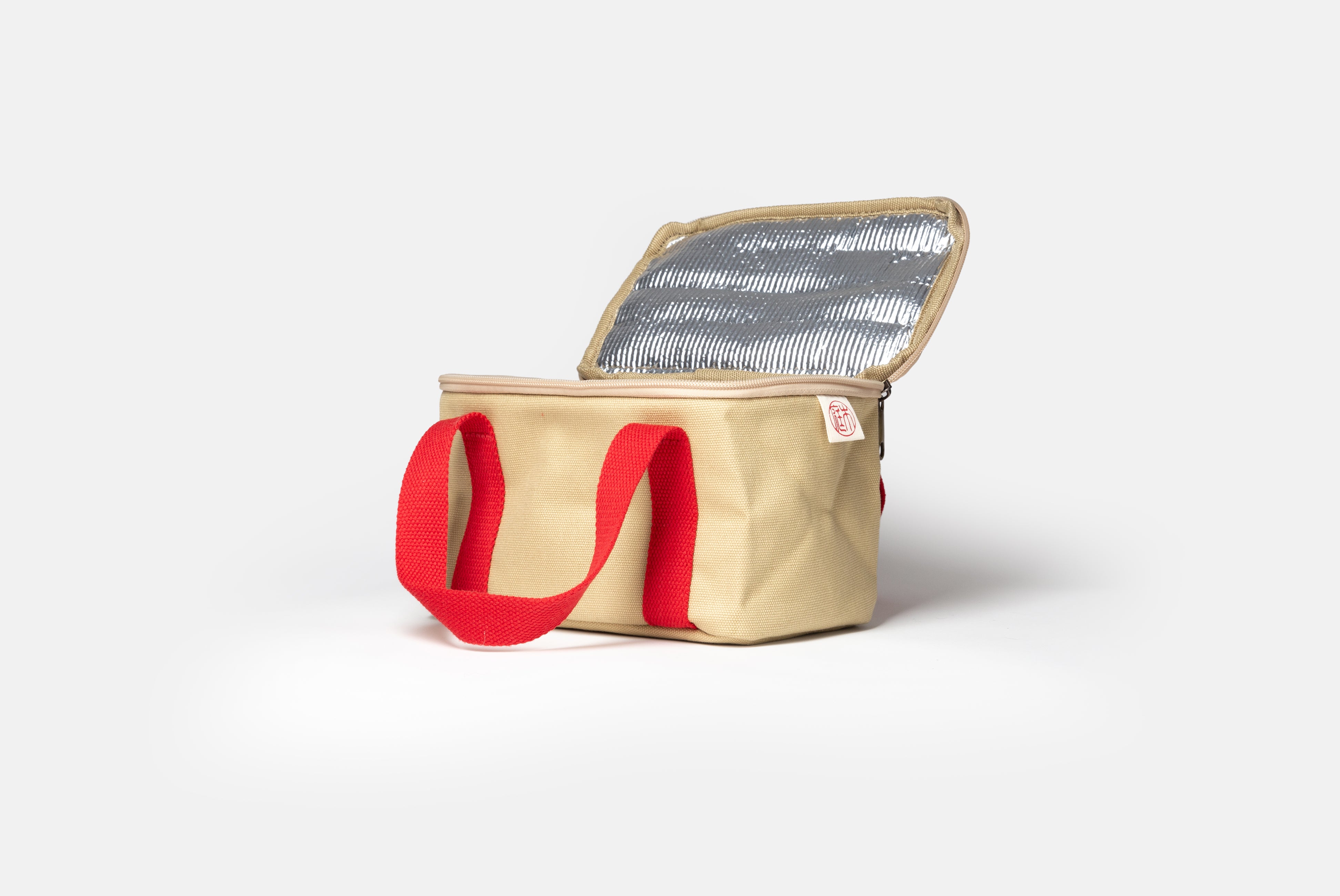 Niwaki Insulated Lunch Bag with red handles, shown open from angle on white background