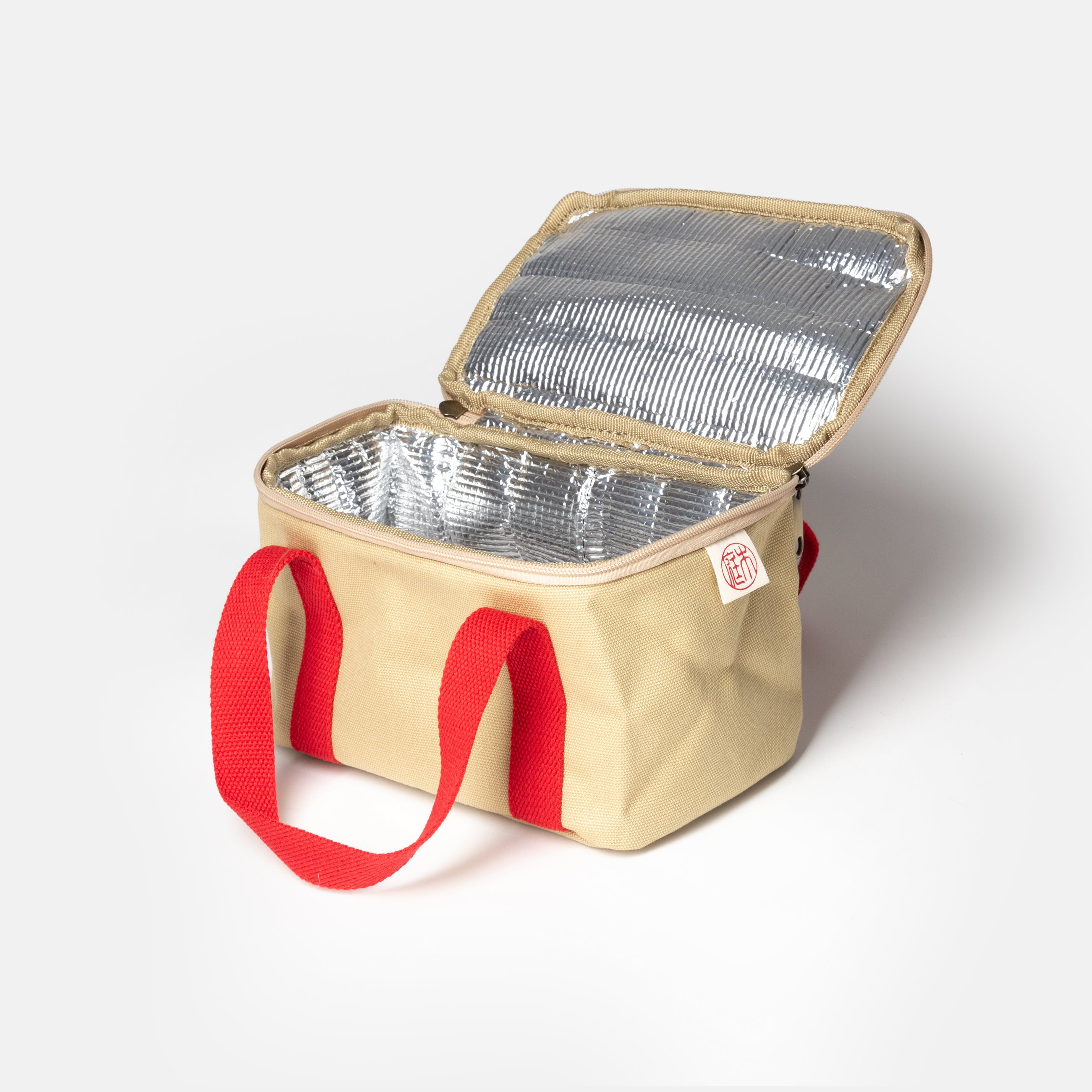 Niwaki Insulated Lunch Bag with red handles, shown open with inside from angle on white background