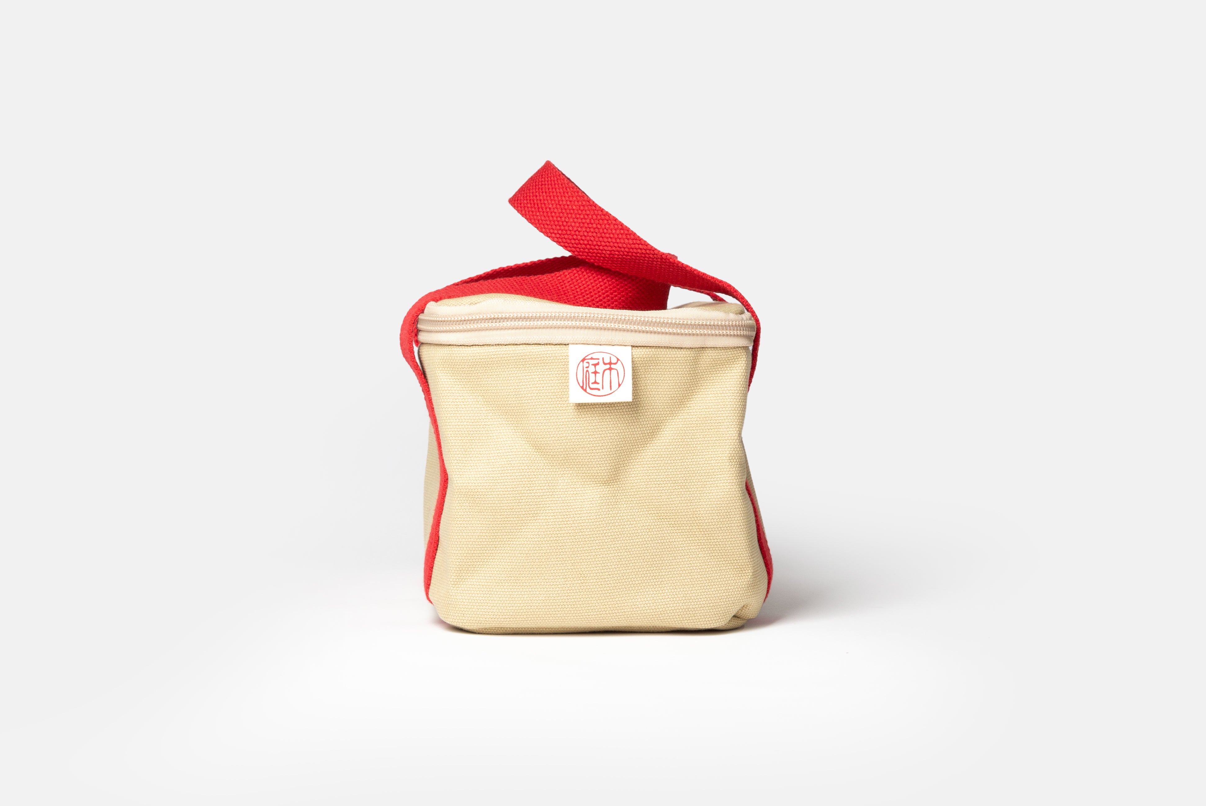 Niwaki Insulated Lunch Bag with red handles, shown from side on white background