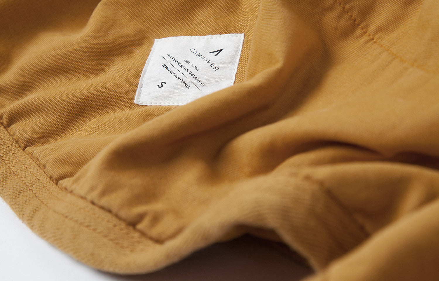 All Purpose Field Blanket in Gold by Campover | Label detail & lifestyle