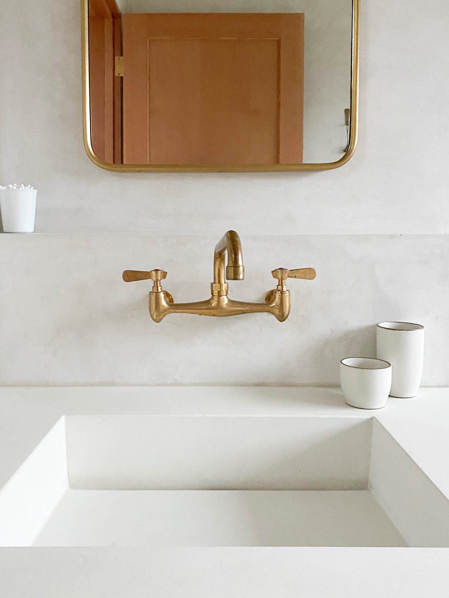 Kinto Nori Tumbler Large and Small on countertop with brass faucet and brass mirror | lifestyle