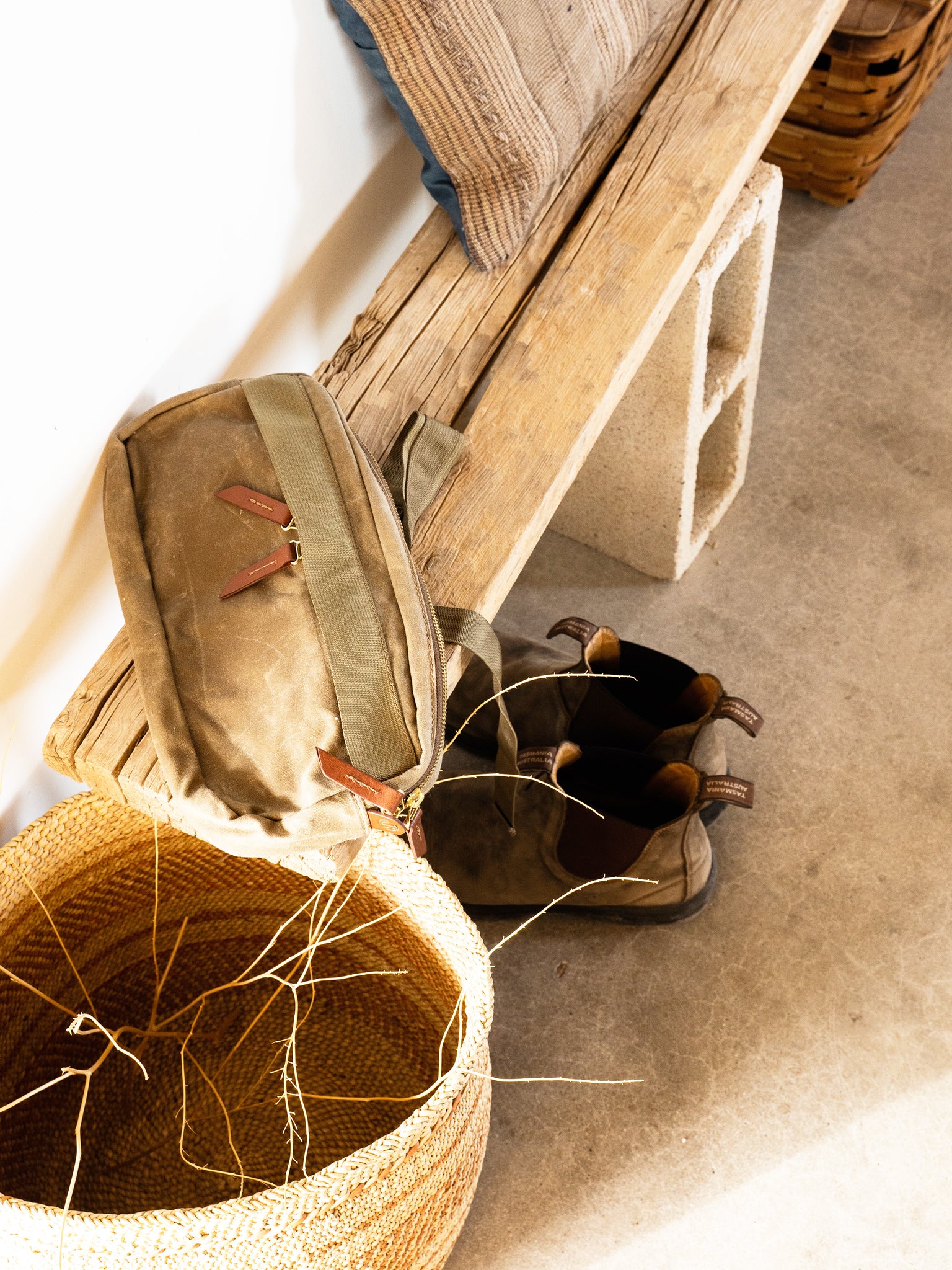 Tanner Goods Crossbody Pack sitting on a bench | lifestyle