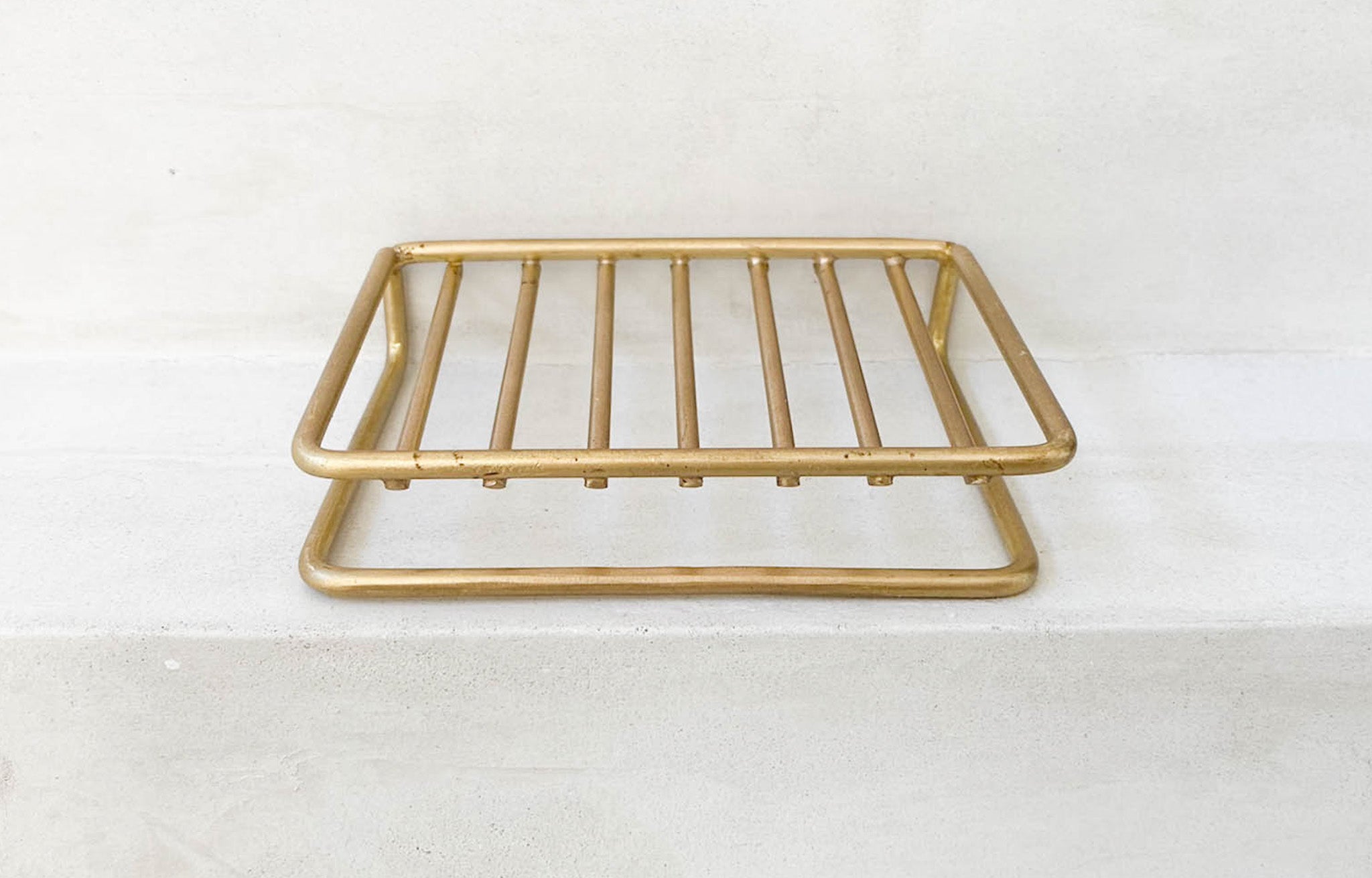 Brass Wire Soap Dish on stucco ledge | lifestyle